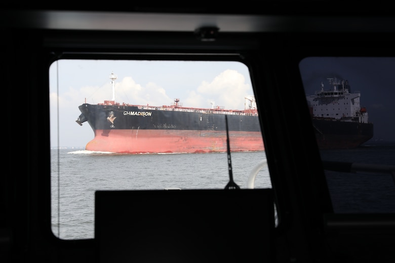 The crude oil tanker GH Madison steams south in the Houston Shipping Channel as the crew of the USACE Galveston District survey boat Tanner II waits for the ship to pass. Between large cargo ships, medium size dredges and small recreational craft, Jason Hiroms, the Tanner II boat captain, keeps his head on a swivel to safely conduct a post dredge survey.