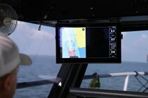 James Hiroms, Galveston District boat captain, watches the computer monitor which shows him the line to drive for an accurate survey. The single beam sonar sends data to shipboard computers to complete the post dredging map.