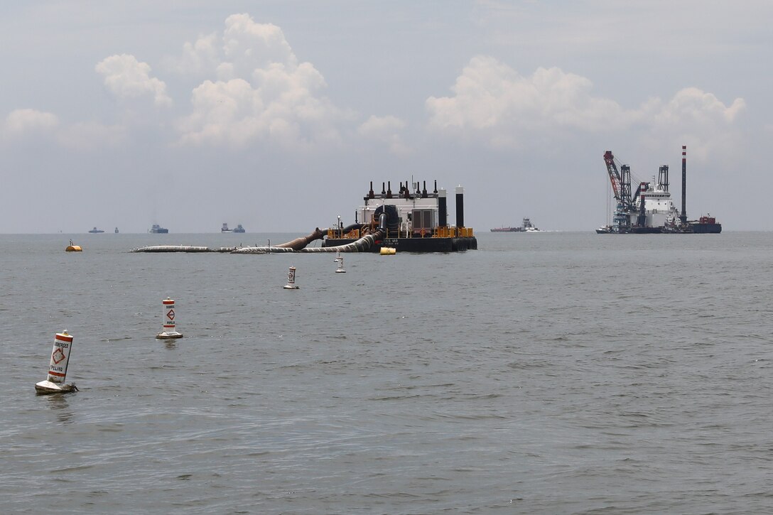 Weeks 189, a dredge pipeline pumping unit, center, works to pump dredge material from the Houston Shipping Channel. On the right is DB Avalon, one of North America’s largest clamshell dredges.