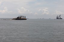Weeks 189, a dredge pipeline pumping unit, center, works to pump dredge material from the Houston Shipping Channel. On the right is DB Avalon, one of North America’s largest clamshell dredges.