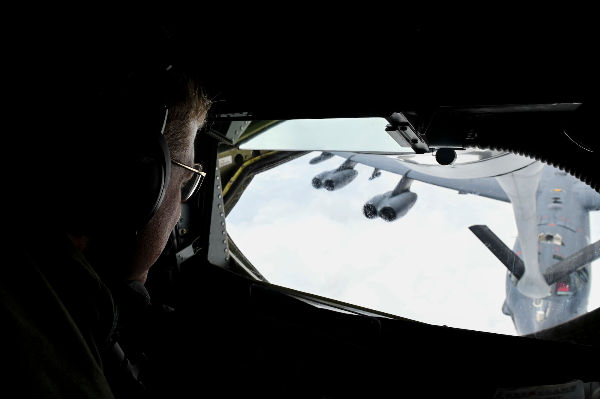 U.S. Air Force Tech Sgt. Steven Hannah, an in-flight refueling specialist assigned to the 384th Air Refueling Squadron, performs an aerial refueling demonstration as part of Operation Centennial Contact out of Fairchild Air Force Base, Washington, June 27, 2023. The movement, which included stops at Yellowstone National Park, Mount Rushmore, and Glacier National Park, was part of Air Mobility Command’s celebration of 100 years air refueling operations and demonstrated the 92nd Air Refueling Wing’s global reach capabilities. Since its inception in 1923, air refueling has become a crucial component of military and civilian aviation operations around the world by extending the range and endurance of aircraft and enabling them to complete missions that would otherwise be impossible or require multiple stops. As a result, this capability is essential for strategic and tactical operations, as well as humanitarian relief efforts in support of AMC, U.S. Transportation Command and Department of Defense priorities. (U.S. Air Force photo by Airman 1st Class Haiden Morris)
