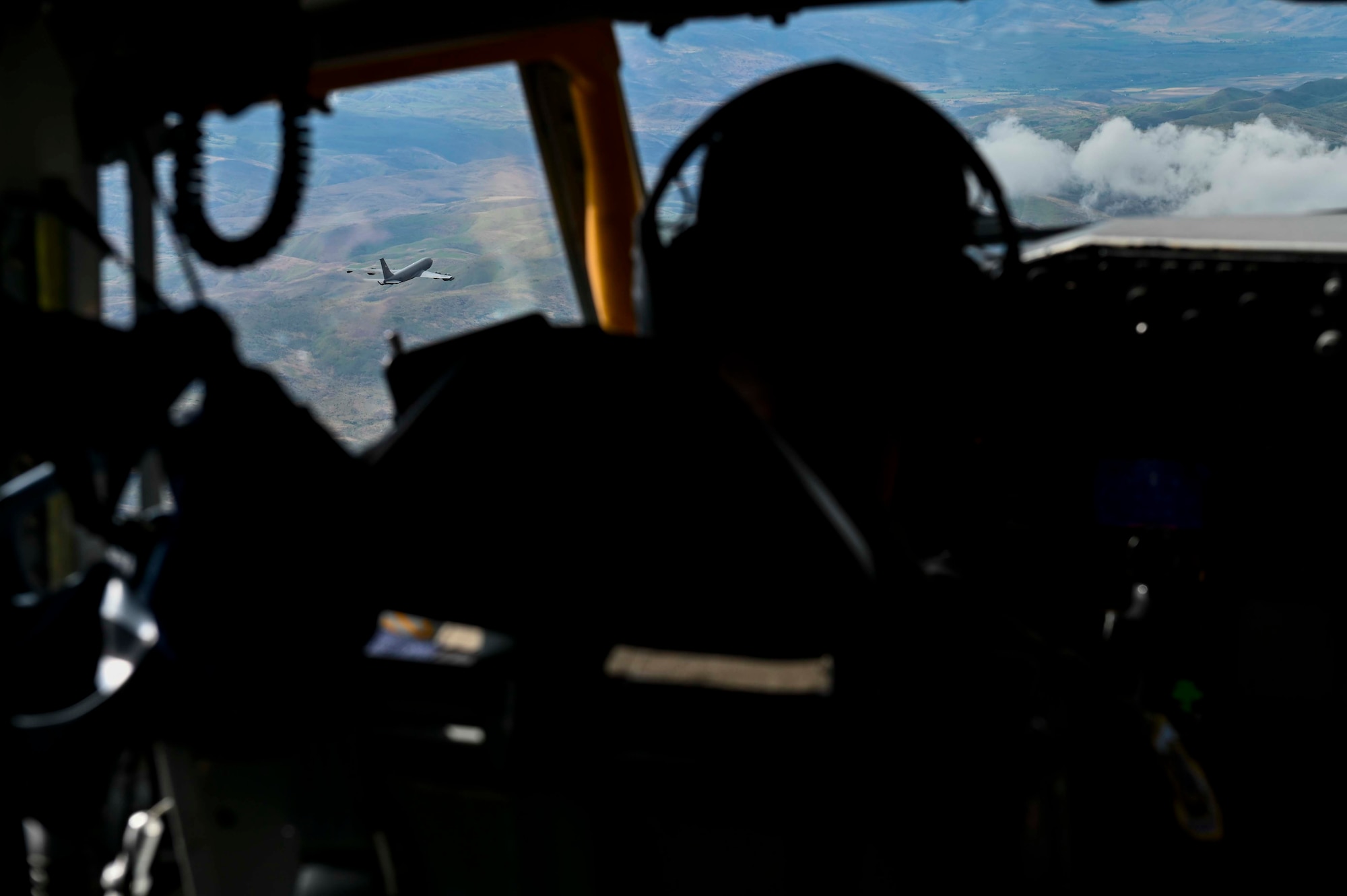 U.S. Air Force Lt. Col. Daniel Schone, a 92nd Air Refueling Squadron pilot, flies a KC-135 Stratotanker as part of Operation Centennial Contact out of Fairchild Air force Base, Wash., June 27, 2023. The movement, which included stops at Yellowstone National Park, Mount Rushmore, and Glacier National Park, was part of Air Mobility Command’s celebration of 100 years air refueling operations and demonstrated the 92nd Air Refueling Wing’s global reach capabilities. Since its inception in 1923, Air refueling has become a crucial component of military and civilian aviation operations around the world by extending the range and endurance of aircraft and enabling them to complete missions that would otherwise be impossible or require multiple stops. As a result, this capability is essential for strategic and tactical operations, as well as humanitarian relief efforts in support of AMC, U.S. Transportation Command and Department of Defense priorities. (U.S. Air Force photo by Airman 1st Class Haiden Morris)