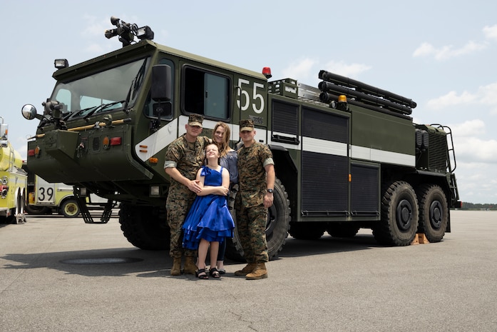 U.S. Marine Corps Master Sgt. Christopher Lisle, left, a regional expeditionary firefighting and rescue chief with Marine Aircraft Control Group-28, poses for a photo with his family after his retirement ceremony at Marine Corps Air Station Cherry Point, North Carolina, June 16, 2023. After a 23-year career, Lisle's legacy will be carried on by his son, Lance Cpl. Devin Lisle, an aircraft rescue and firefighting specialist with Headquarters and Headquarters Squadron 751.