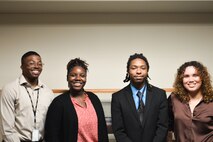 Strategic Systems Programs welcomed its inaugural class of interns from Historically Black Colleges and Universities (HBCU) and Minority Institutions (MI) at an event at SSP Headquarters Wednesday, 28 June, where they were introduced to the workforce and connected with peer mentors and other HBCU/MI alumni. Pictured, standing in a group are, Fernandes Boyd (far left) and Jashianette Fournier Jaiman (far right), cohort leaders and HBCU alumni, welcomed Jayla Bryan (center left) and Emmanuel Faulkner (center right) during the event. The SSP-cohort is a part of the Department of the Navy's wide-reaching effort to expand HBCU/MI recruitment and support STEM activities at institutions that have been historically underrepresented in Navy outreach efforts (U.S. Navy Photo by Delaney Burlingame/Released)