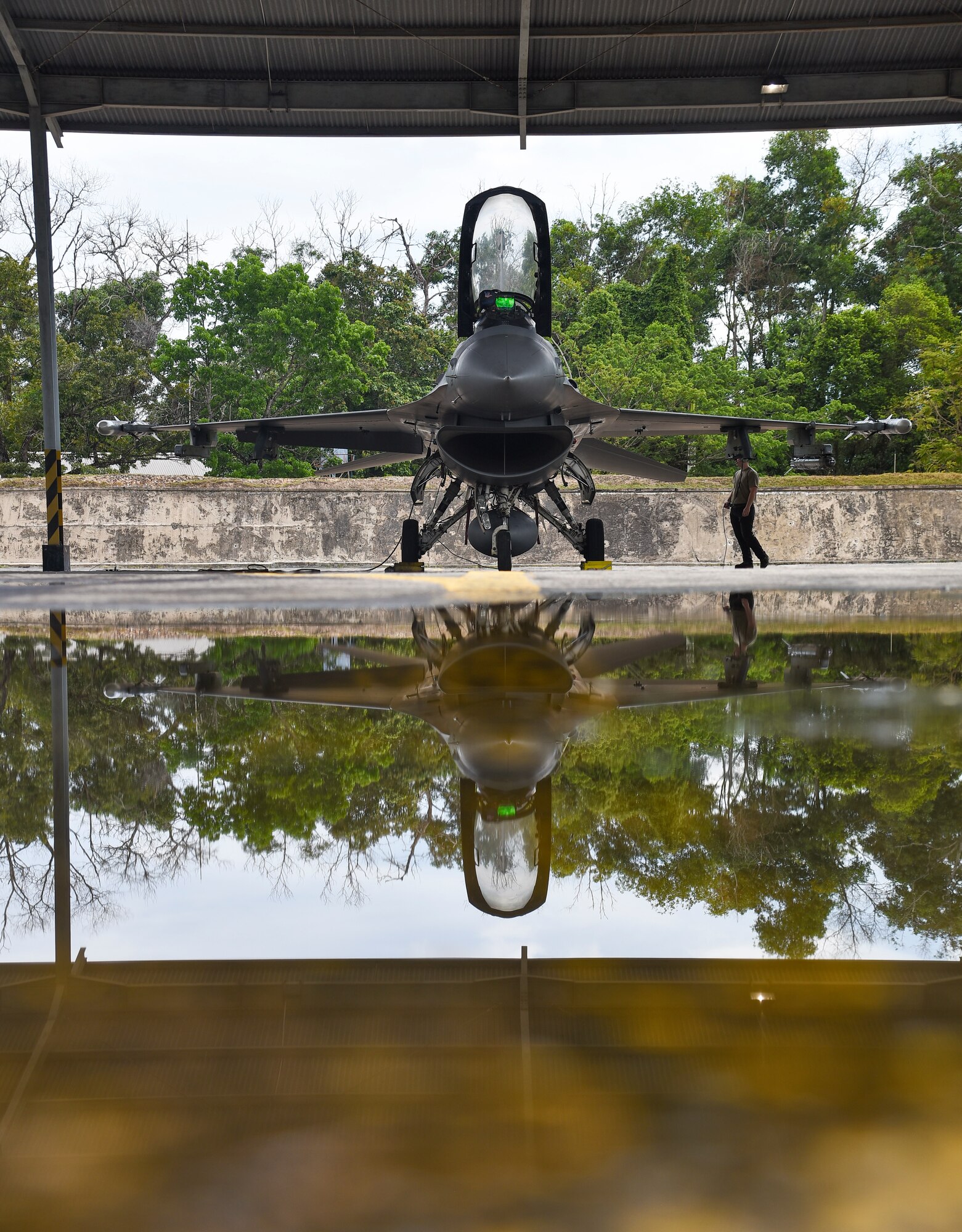 A plane is reflected in a puddle