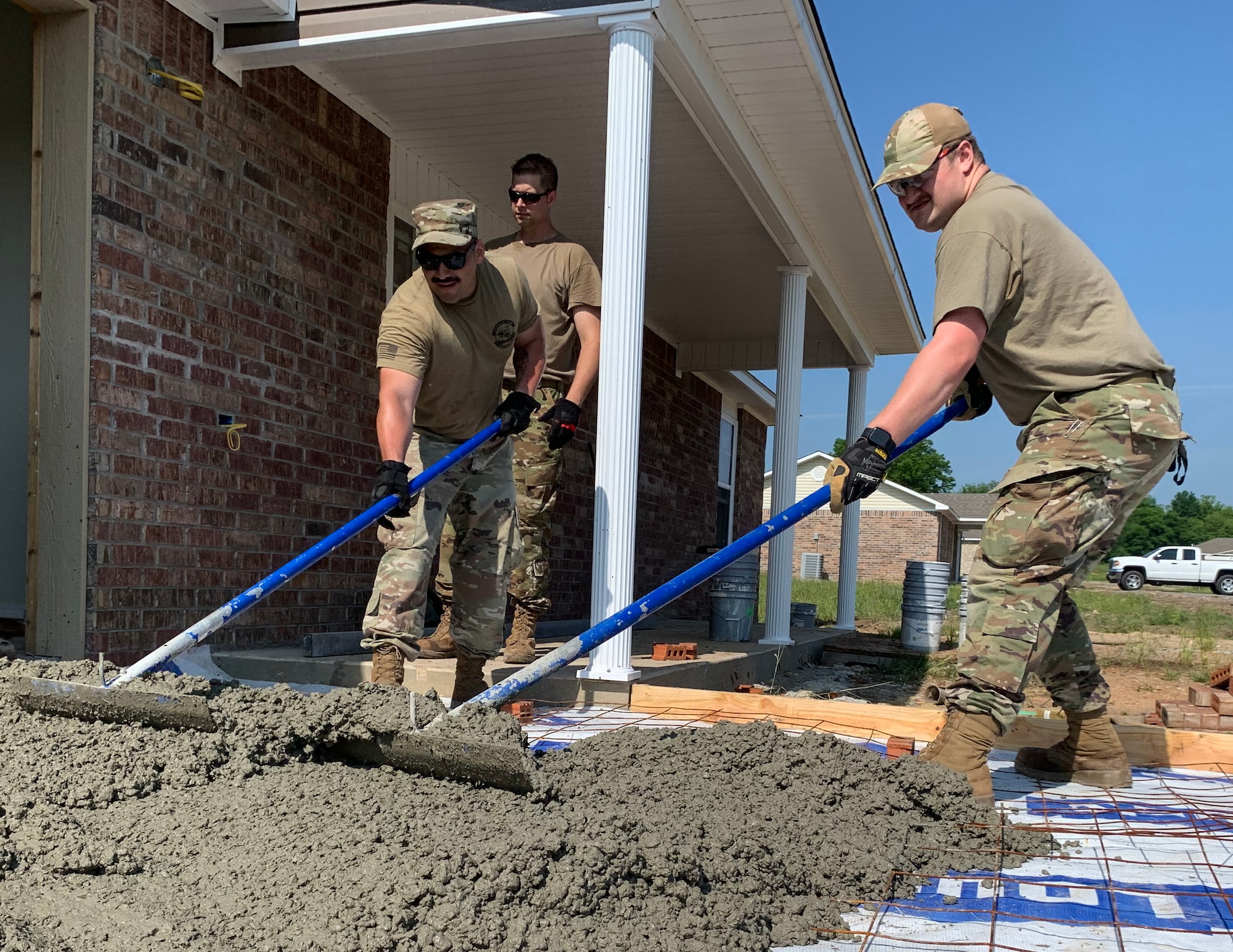 U.S. Air Force Senior Airman Mitchell Krogman and Airman 1st Class Travis, 133rd Civil Engineer Squadron, assisting with concrete pour in Tahlequah, Olka., May 22, 2023.