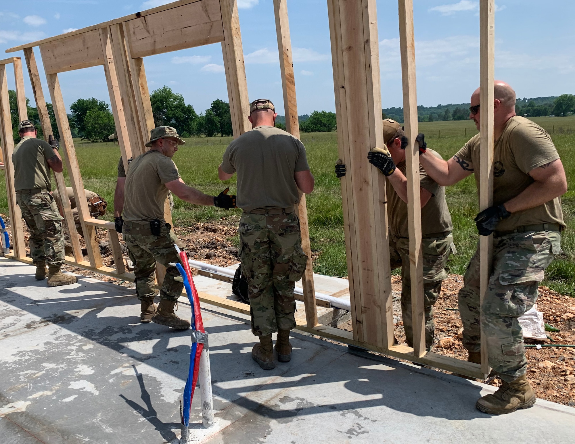 U.S. Air Force Airmen from the 133rd Civil Engineer Squadron place newly created frames on the house's foundation in Tahlequah, Olka., May 22, 2023.