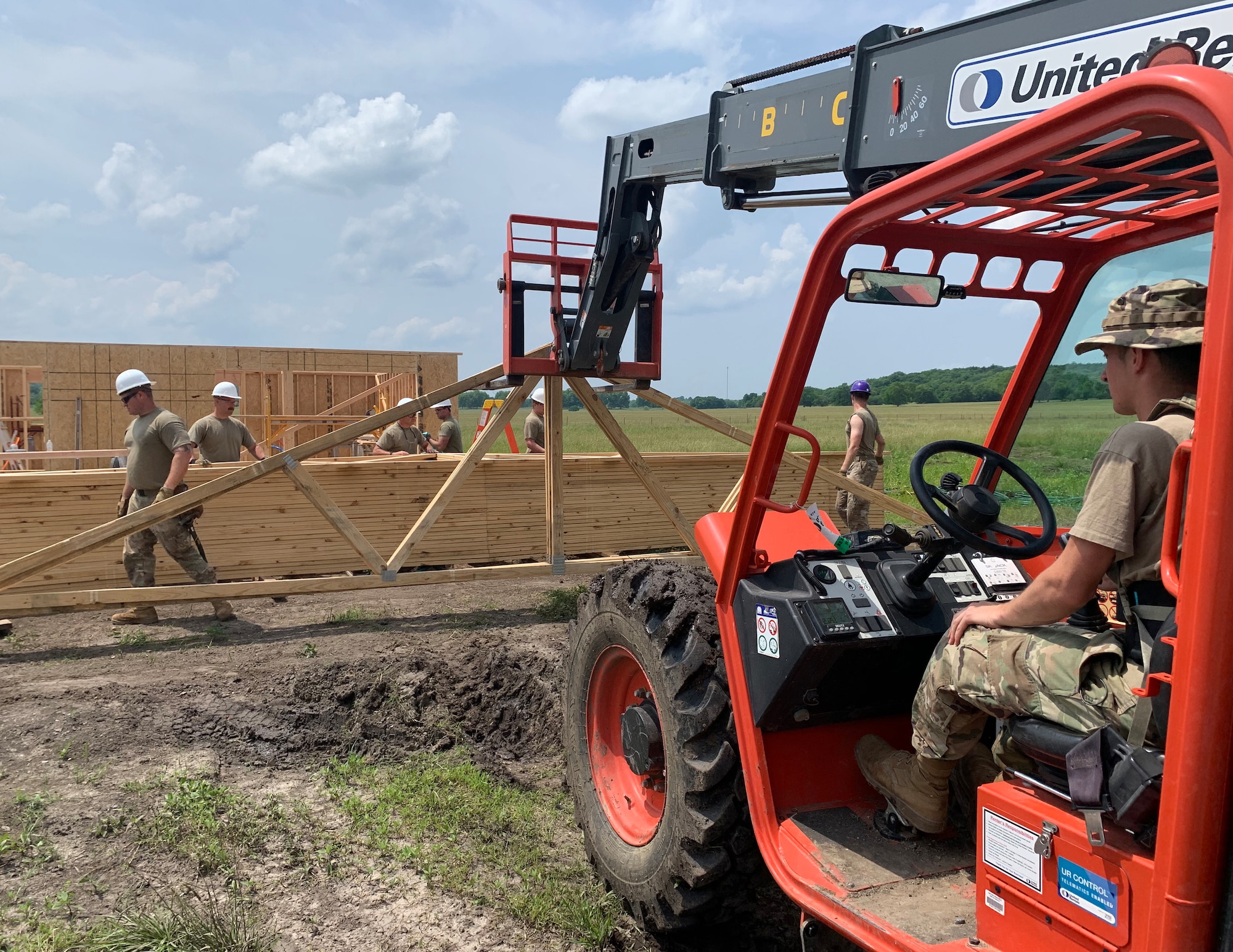 U.S. Air Force Airmen from the 133rd Civil Engineer Squadron lift trusses in Tahlequah, Olka., May 25, 2023.