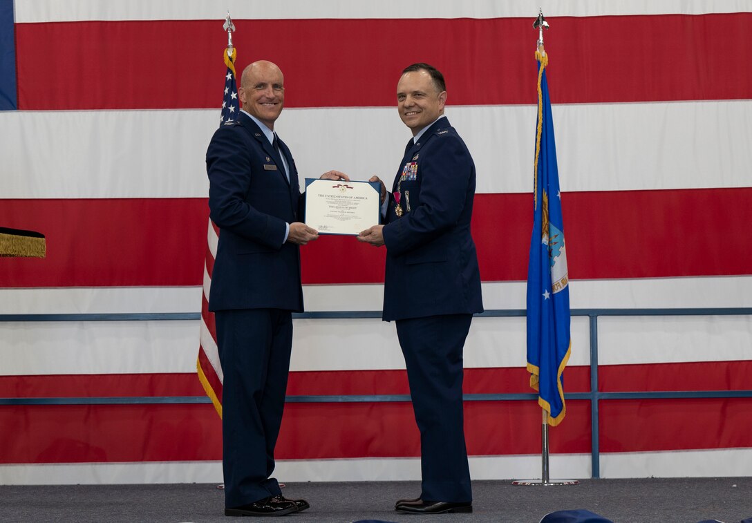 U.S. Air Force Col. Derek Oakley, 28th Bomb Wing commander, left, awards Col. Nathan Mitchell, outgoing 28th Maintenance Group commander, the Legion of Merit at Ellsworth Air Force Base, South Dakota, June 29, 2023.