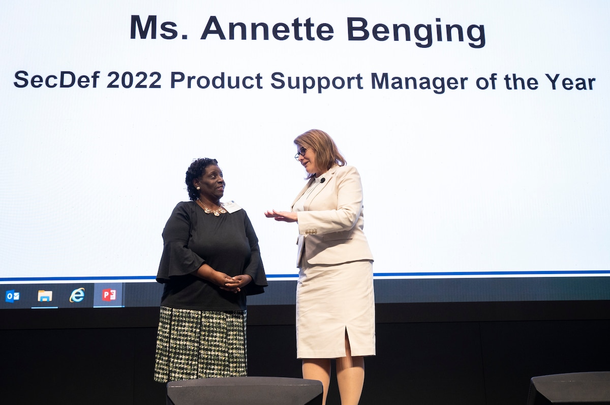 Two women on stage talking.