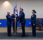 Lt. Col. Lena Williams Cox receives the 559 Trainee Health Squadron guidon flag which signifies their unit designation and branch/corps affiliation or the title of the individual who carries it.