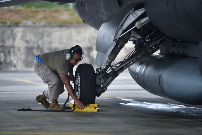 Man removes chalks from wheel