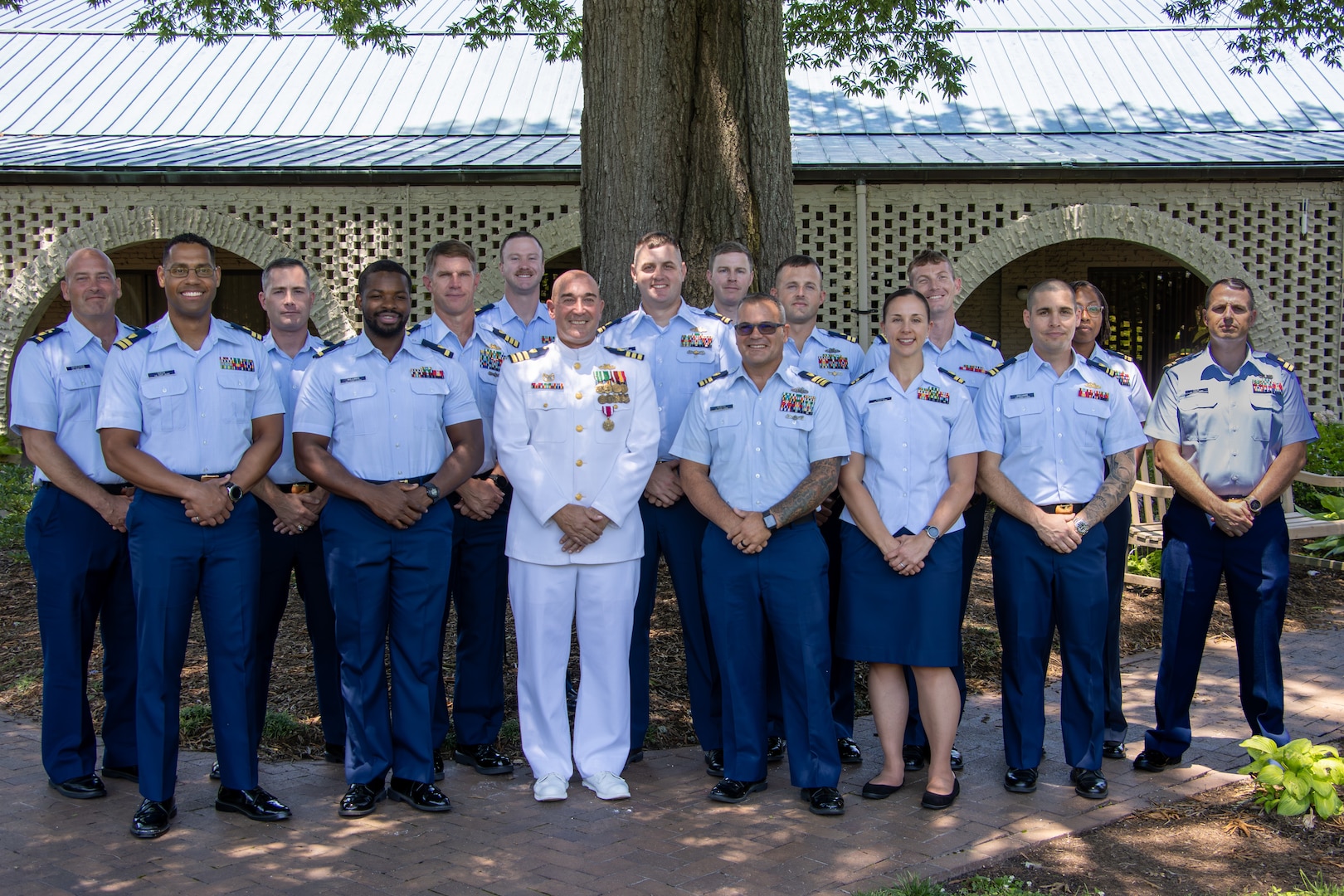 Cmdr. James Lovenstein stands with members from the Port Security Unit 305’s wardroom following PSU 305’s change of command ceremony in Newport News, Virginia, June 27, 2023. Cmdr. John Elkins relieved Cmdr. Lovenstein as the commanding officer of PSU 305, Capt. Jason Ryan, chief of Pacific Area operations, presided over the ceremony. U.S. Coast Guard courtesy photo.