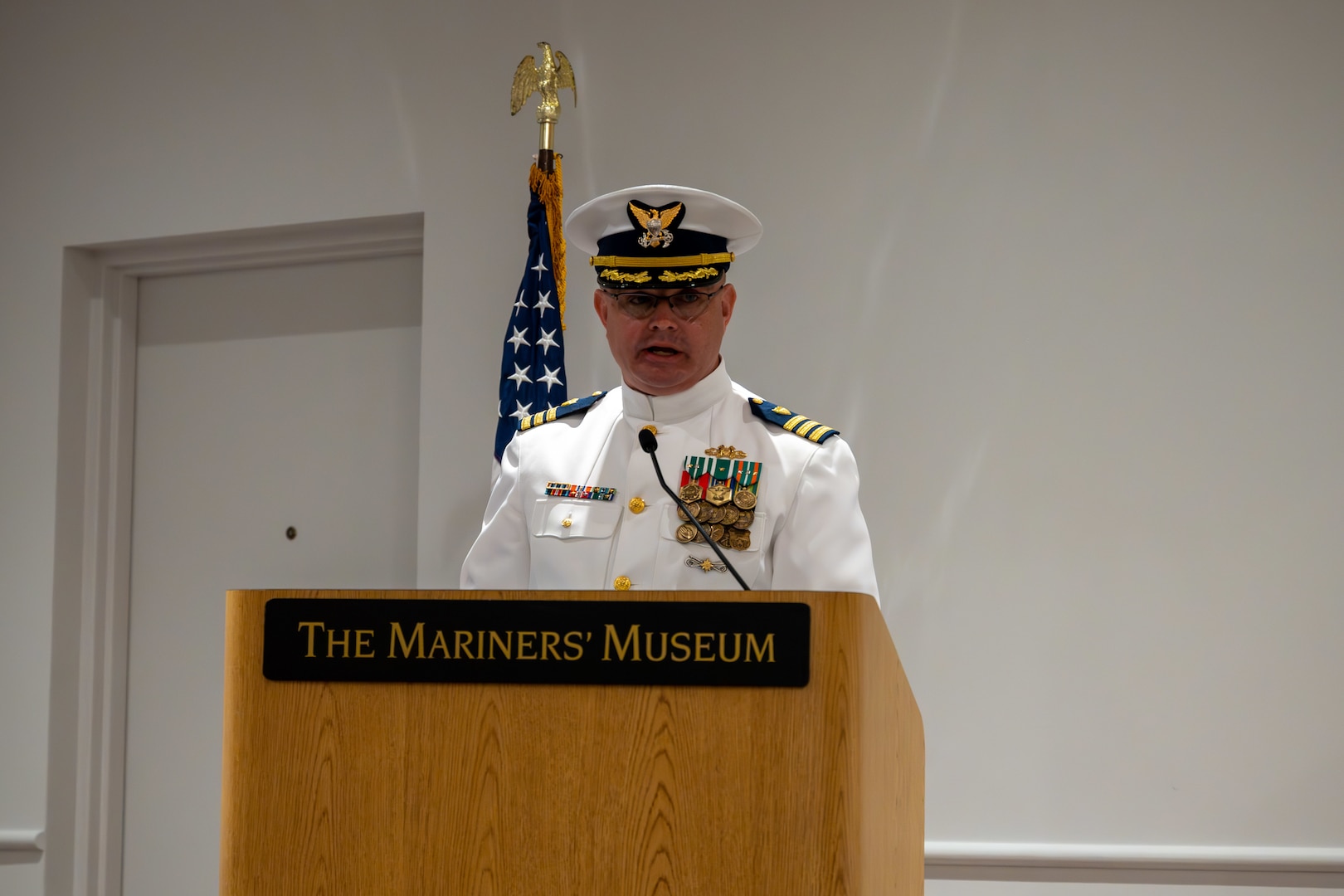 Cmdr. John Elkins delivers a speech to his new crew after assuming the role of Port Security 305’s commanding officer during the change of command ceremony in Newport News, Virginia, June 27, 2023. Elkins relieved Cmdr. James Lovenstein as the commanding officer of PSU 305, Capt. Jason Ryan, chief of Pacific Area operations, presided over the ceremony. U.S. Coast Guard courtesy photo.