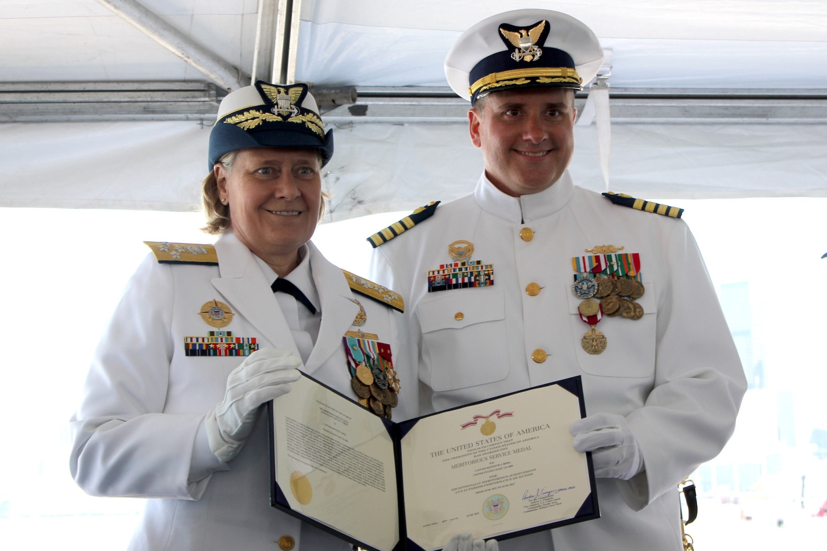 Adm. Linda Fagan, commandant of the U.S. Coast Guard, presents Capt. Kenneth Boda, commanding officer of Coast Guard Cutter Healy (WAGB 20), with a Meritorious Service Medal during a change of command ceremony, June 29, 2023, aboard Healy, at Base Seattle. Under Boda's command, the crew aboard Healy circumnavigated North America in 2021 and reached the North Pole in 2022, among other notable accomplishments. (U.S. Coast Guard photo by Petty Officer 2nd Class Michael Clark)