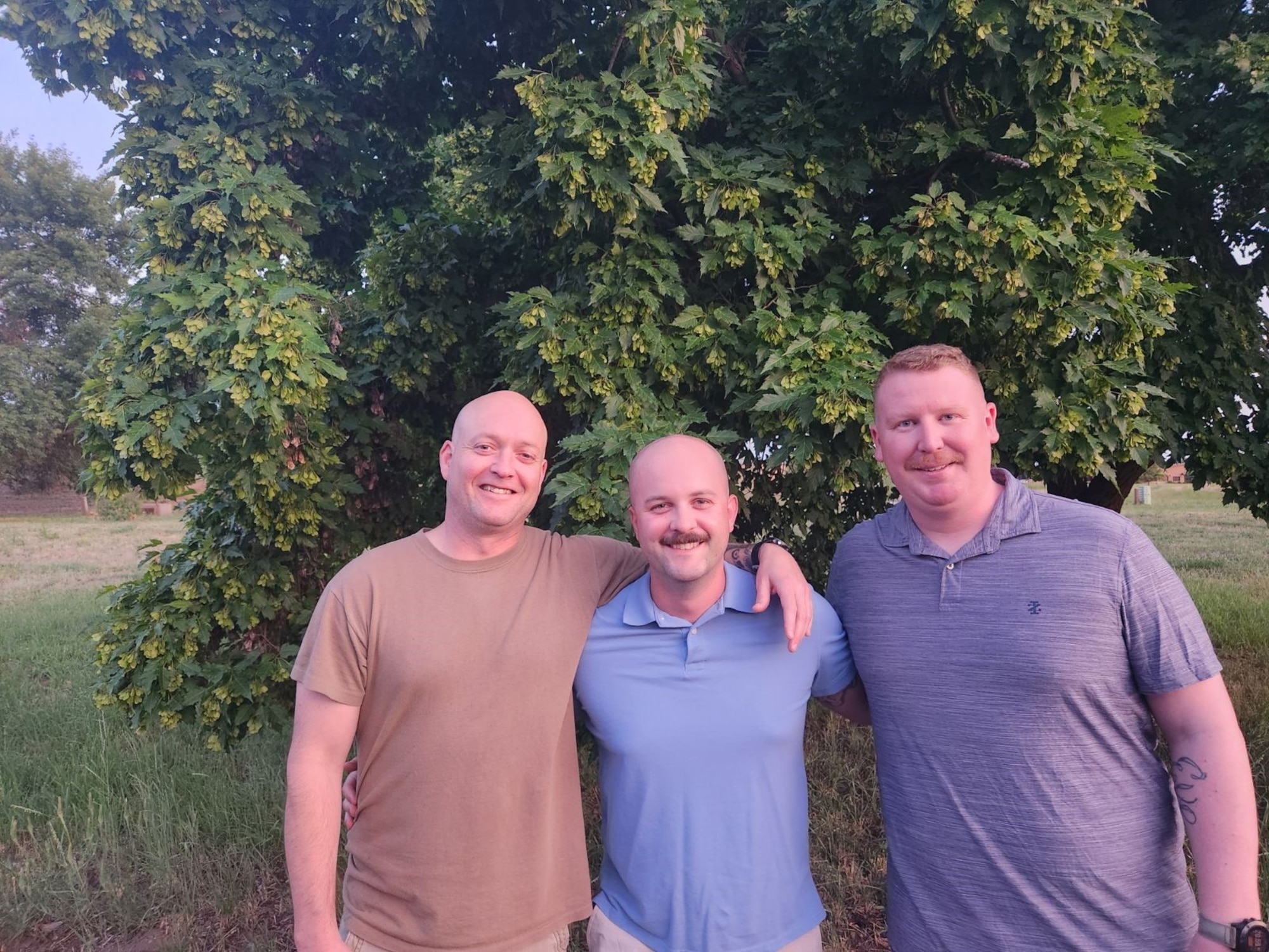 U.S. Air Force Master Sgt. Jesse Wright (left), 92nd Air Refueling Wing Squadron Operations Superintendent; Tech Sgt. Nathaniel Perry (center), 92nd Air Refueling Wing noncommissioned officer in charge of  standards and evaluations; and Master Sgt. Mathew Ohle, 92nd Air Refueling Squadron senior enlisted leader, pose for a photo at Clear Lake Resort, Washington, June 23rd, 2023. The three Airmen rescued an injured seaplane pilot after an attempted landing in Clear Lake resulted in the plane being turned upside down. (Photo courtesy of Tech Sgt. Nathaniel Perry)