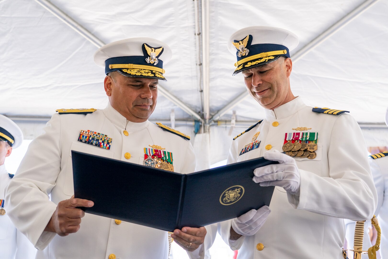 Vice Adm. Andrew Tiongson, the Coast Guard Pacific Area commander, presents the Meritorious Service Medal to Cmdr. Matthew Kolodica during the Coast Guard Cutter Alert's (WMEC 630) change of command ceremony in Astoria, Oregon, June 29, 2023. During the ceremony, Cmdr. Lee Crusius relieved Kolodica as the cutter’s commanding officer. (U.S. Coast Guard photo by Petty Officer 1st Class Travis Magee)