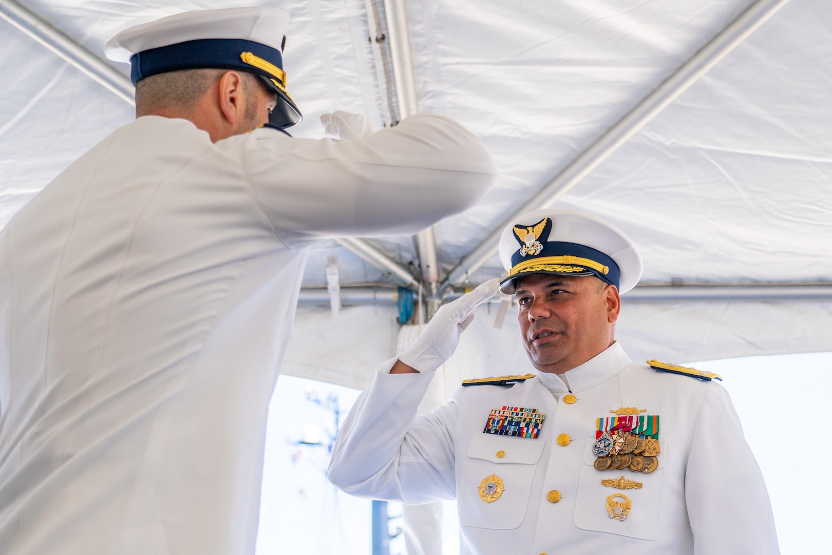 Cmdr. Lee Crusius, the commanding officer of Coast Guard Cutter Alert (WMEC 630), salutes Vice Adm. Andrew Tiongson, the Coast Guard Pacific Area commander during Alert's change of command ceremony in Astoria, Oregon, June 29, 2023. During the ceremony, Crusius relieved Cmdr. Matthew Kolodica as the cutter’s commanding officer. (U.S. Coast Guard photo by Petty Officer 1st Class Travis Magee)