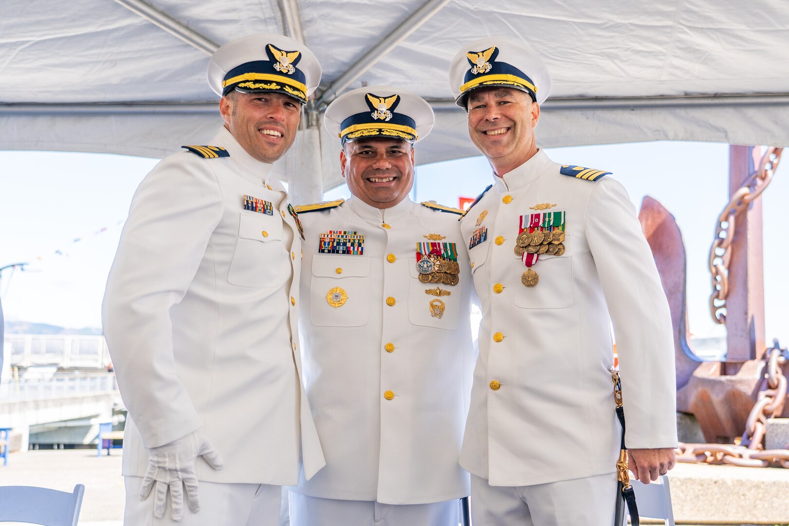 Vice Adm. Andrew Tiongson (center), Coast Guard Pacific Area commander, Cmdr. Lee Crusius (left), the commanding officer of Coast Guard Cutter Alert, and Cmdr. Matthew Kolodica (right) pose for a photo during Alert's change of command ceremony in Astoria, Oregon, June 29, 2023. During the ceremony, Crusius relieved Kolodica as the cutter’s commanding officer. (U.S. Coast Guard photo by Petty Officer 1st Class Travis Magee)