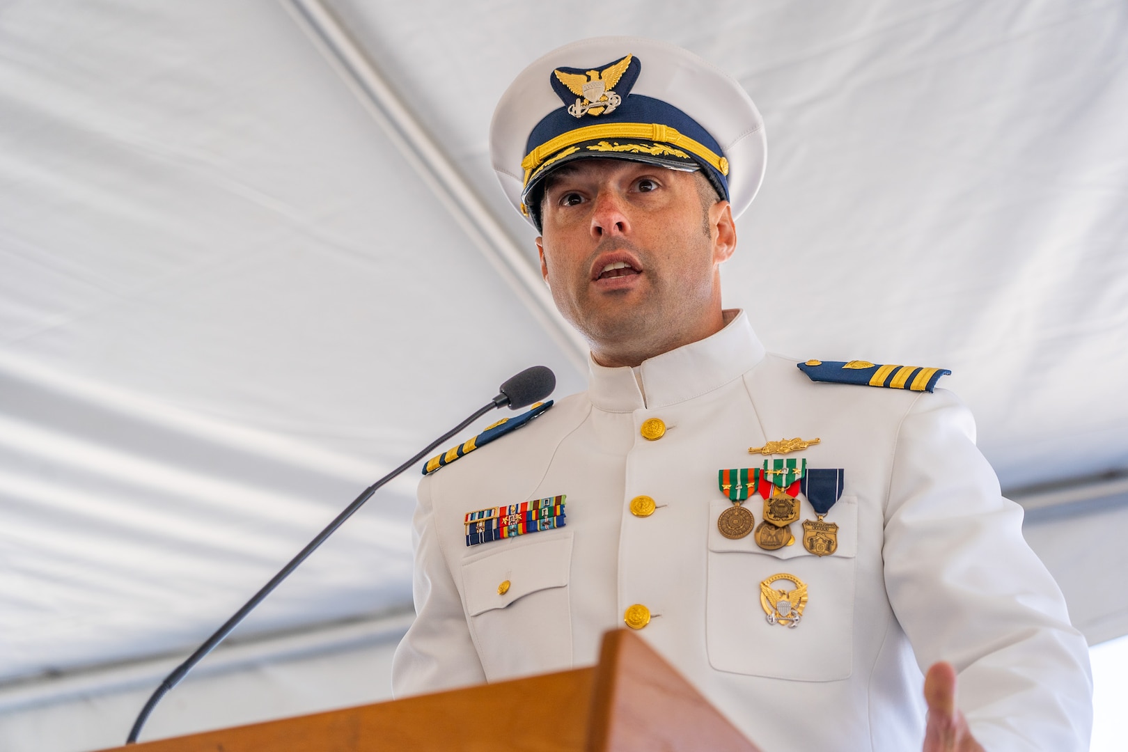 Cmdr. Lee Crusius, the commanding officer of Coast Guard Cutter Alert (WMEC 630), speaks during a change of command ceremony in Astoria, Oregon, June 29, 2023. During the ceremony, Crusius relieved Cmdr. Matthew Kolodica as the cutter’s commanding officer. (U.S. Coast Guard photo by Petty Officer 1st Class Travis Magee)