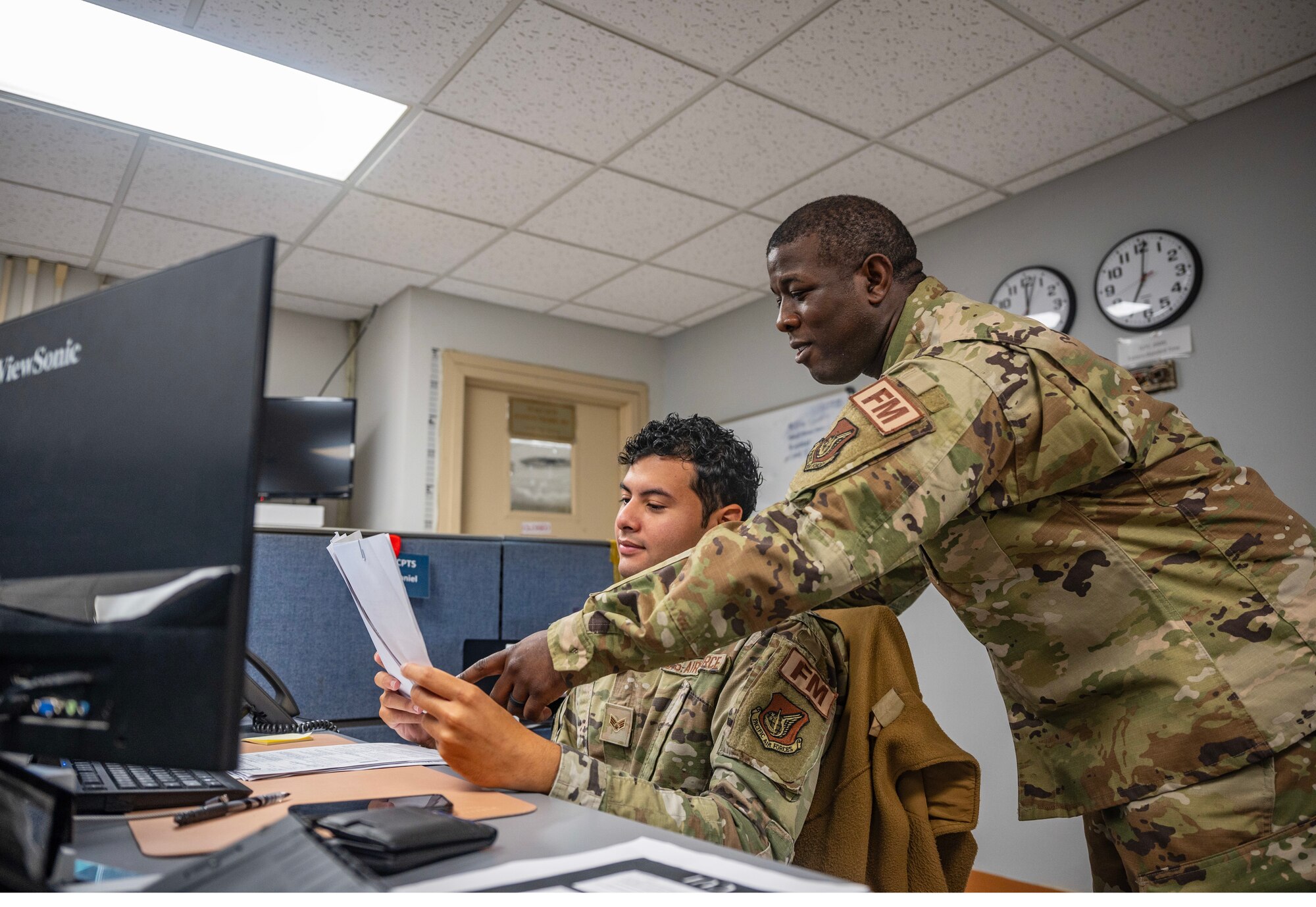 Tech. Sgt. Andrew Madden and Nathan Galarza review pay records at Kunsan Air Base.