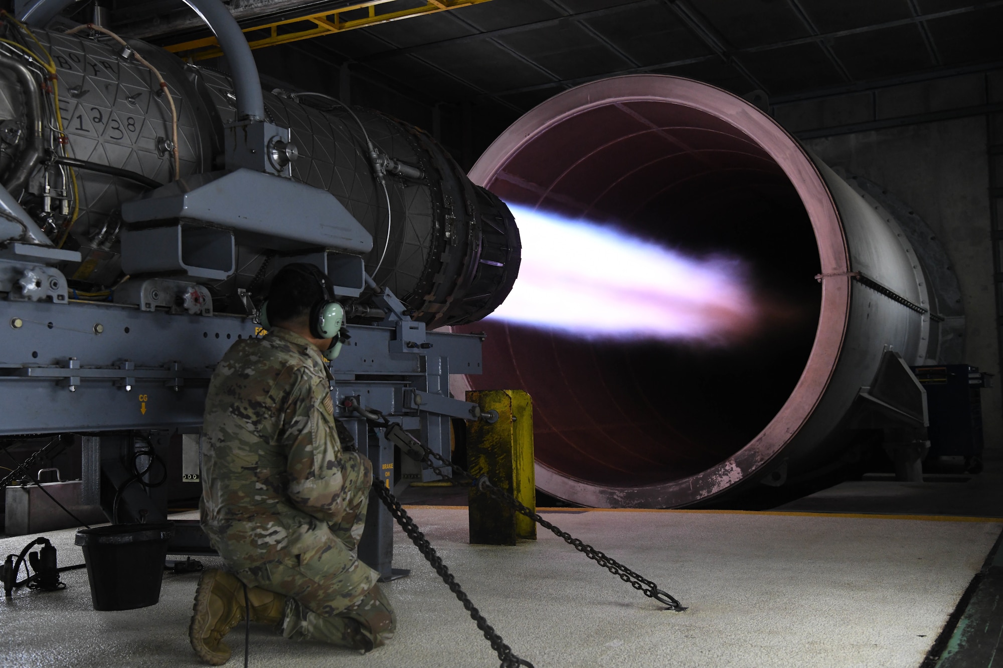 U.S. Air Force Senior Airman inspects an active F-15C  engine.