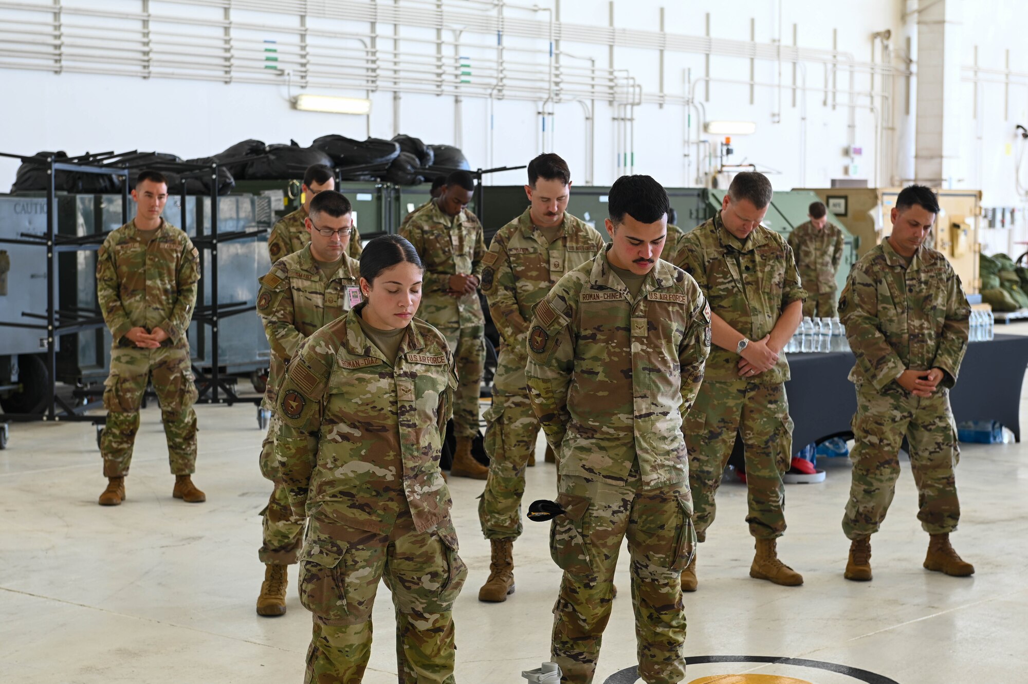 U.S. Air Force Airmen lower their heads during a prayer at the 36th Wing change of command ceremony at Andersen Air Force base, Guam, June 30, 2023.