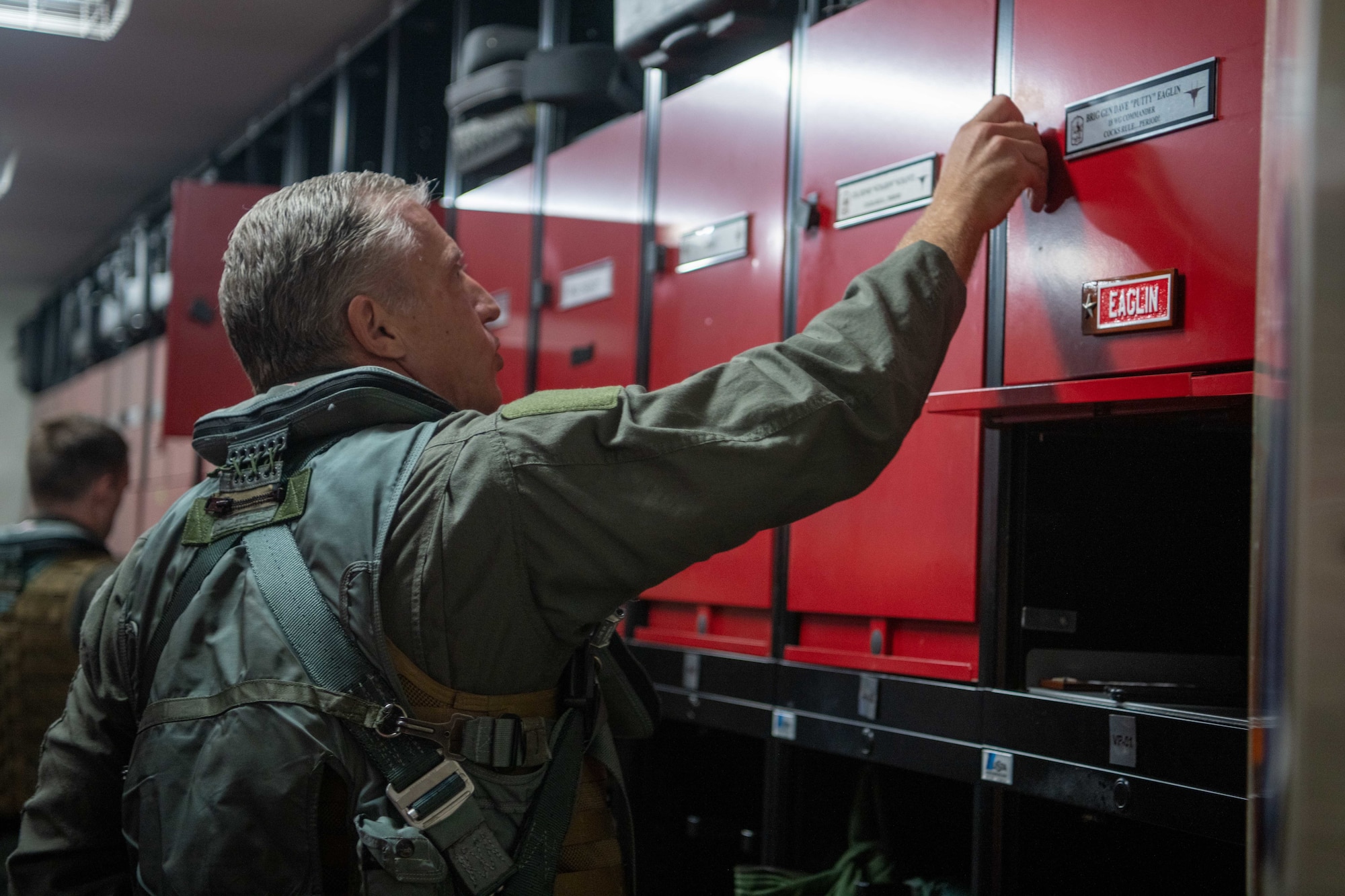 A pilot shuts his locker door.