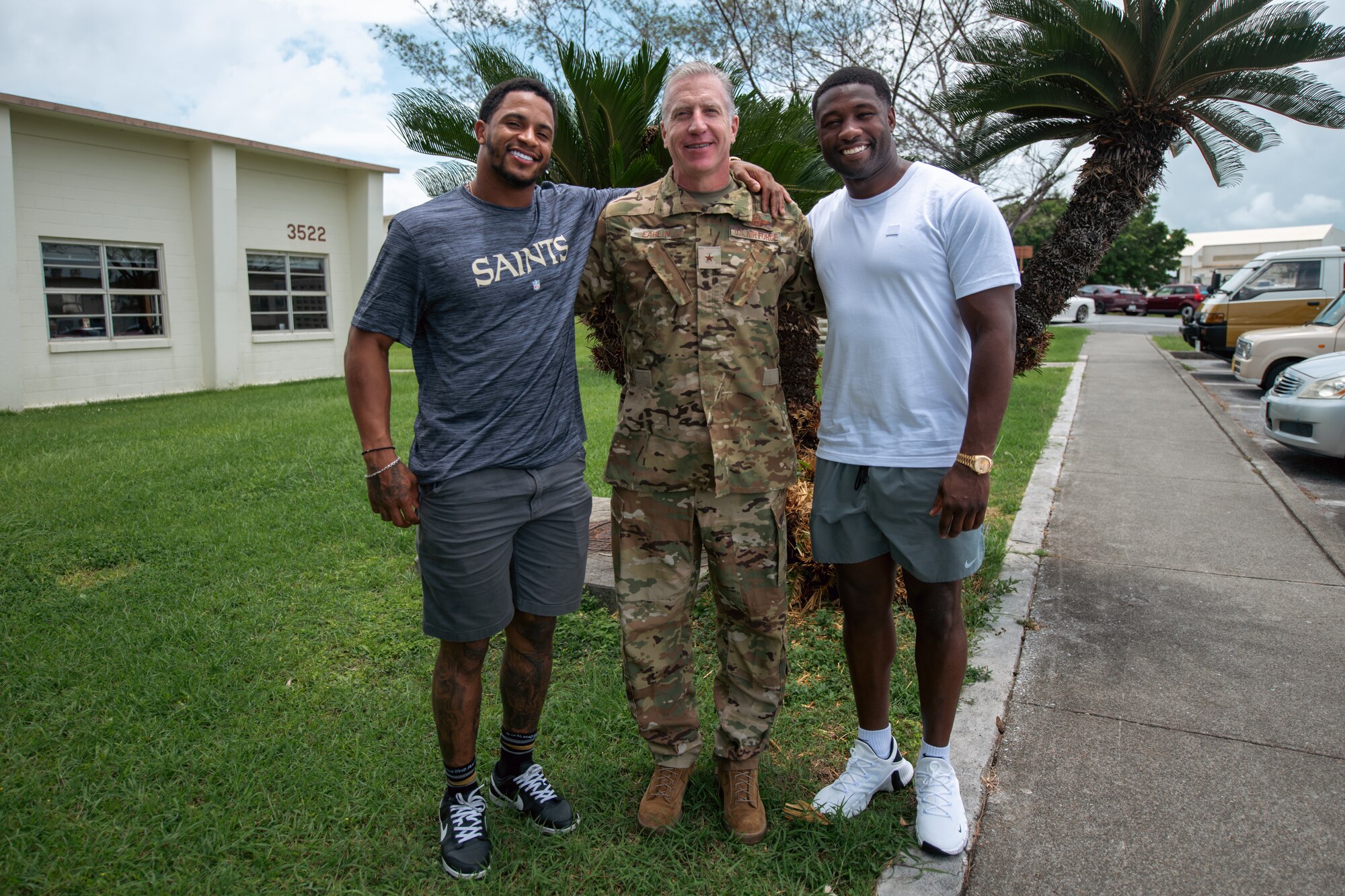 Three men pose for a photo.