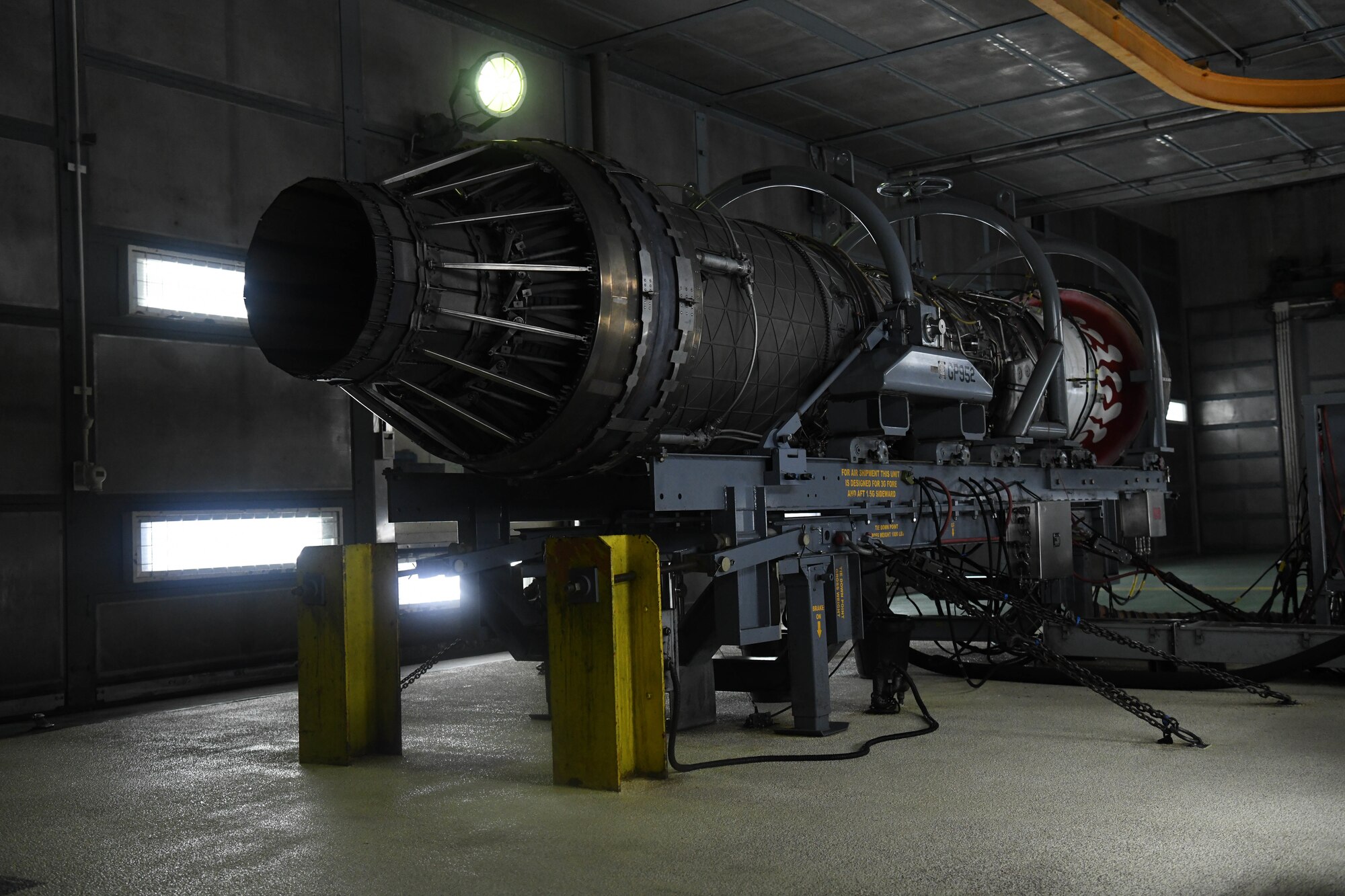 An F-15C jet engine is prepared to be tested in a full afterburner state