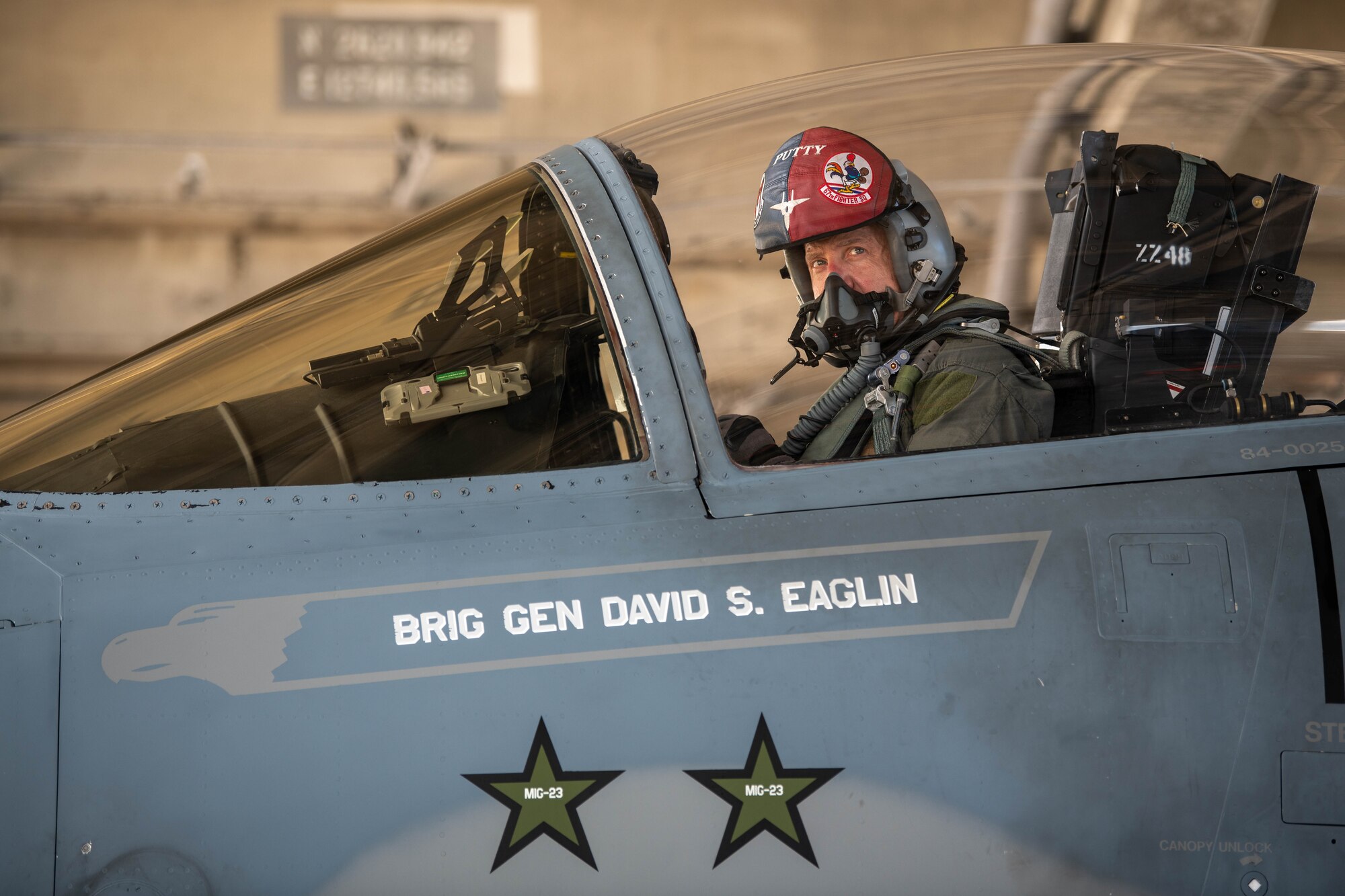 A pilot sits in the cockpit of an aircraft.