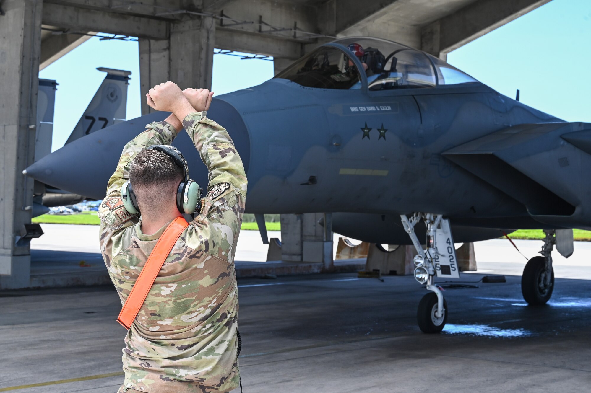 An Airman marshals an aircraft.