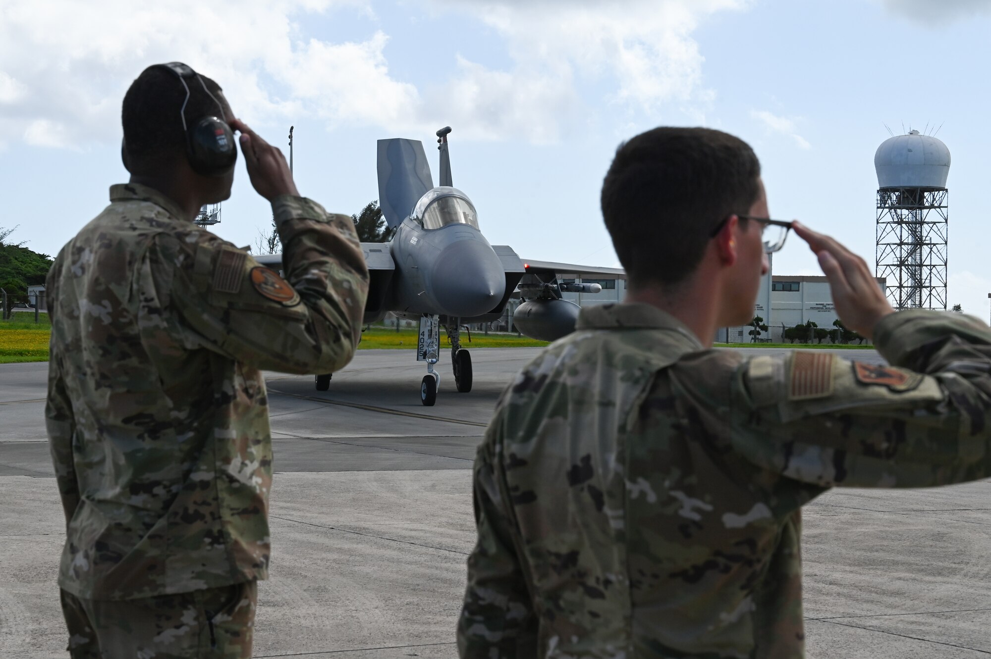 Airmen salute the commander as he taxis by.