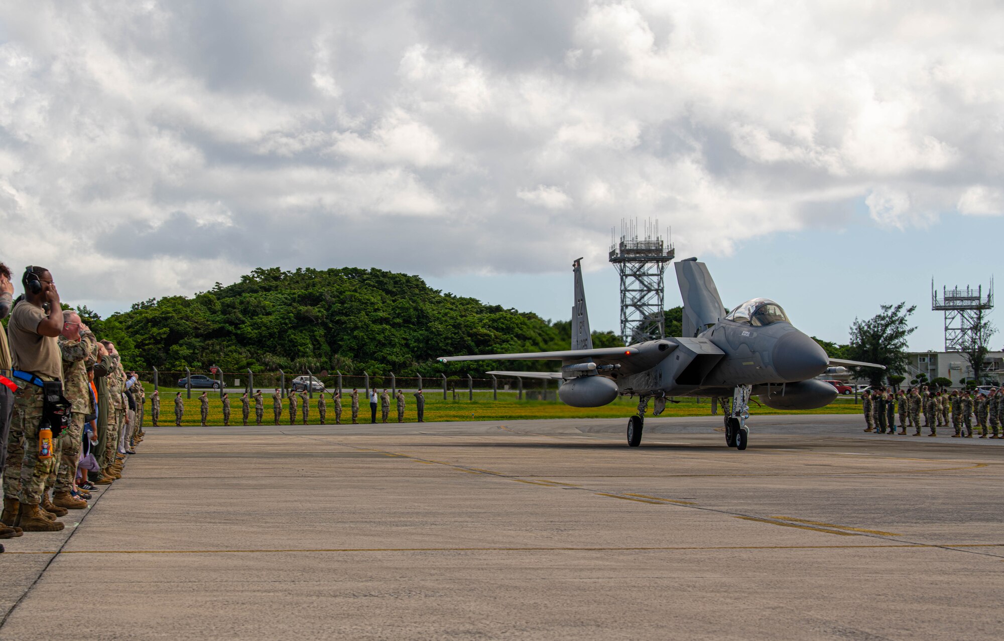 Airmen salute the commander as he taxis by.