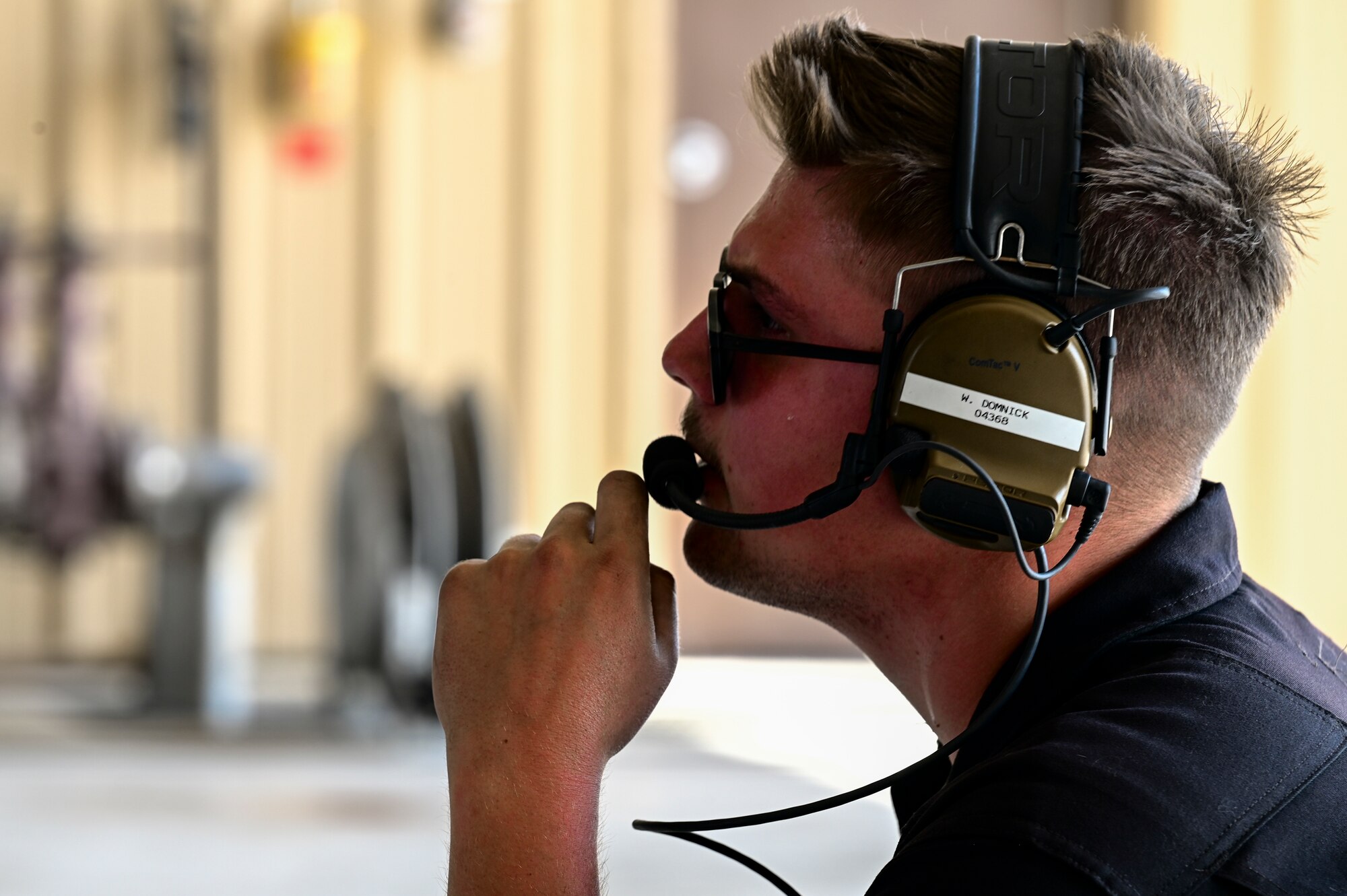 U.S. Air Force Senior Airman William Domnick, 849th Aircraft Maintenance Squadron assistant dedicated crew chief, communicates with an F-16 Viper pilot at Holloman Air Force Base, New Mexico, June 27, 2023.
