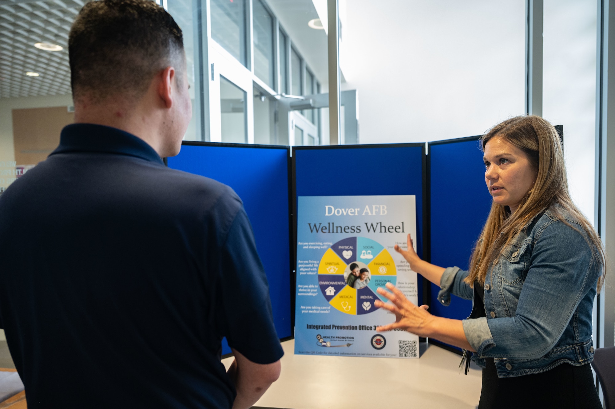 Kelly Dixon, 436th Operational Medical Readiness Squadron health promotions coordinator, explains the Wellness Wheel to Senior Airman Andrew Sinnott, 436th Force Support Squadron fitness center specialist, on Dover Air Force Base, June 26, 2023. The interactive resource is a promotional tool that allows users to assess all aspects of their personal wellness, including physical, social, financial, spiritual, personal growth, environment, and mental wellness. 
The Wellness Wheel can be accessed at https://www.doverfss.com/dafb-wellness-wheel. (U.S. Air Force photo by Senior Airman Cydney Lee)