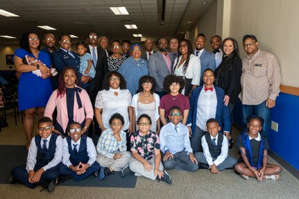 Group photo of Lt. Col. Lena Williams Cox and her family after the 559th Trainee Health Squadron Change of Command Ceremony.