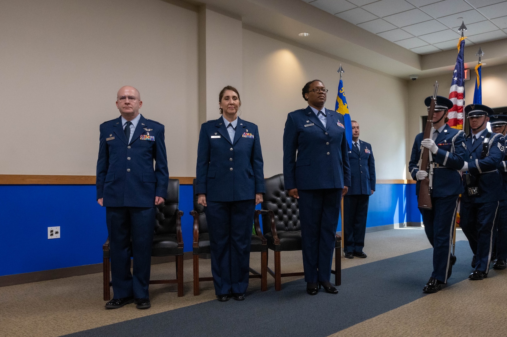 Members of the official party stand at the position of attention while the Joint Base San Antonio Honor Guard posts the colors at Joint Base San Antonio- Lackland, Texas