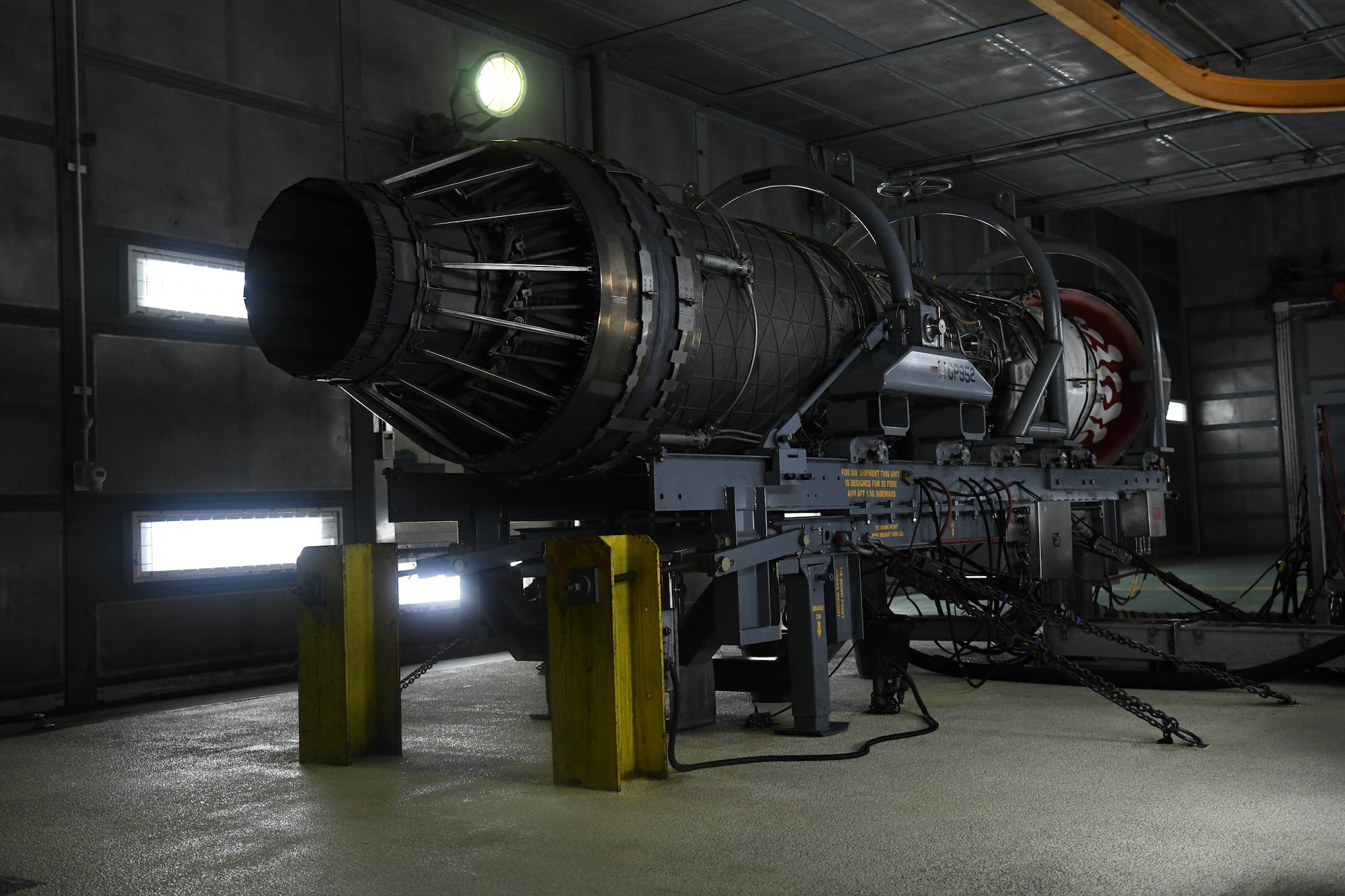An F-15C jet engine is prepared to be tested in a full afterburner state