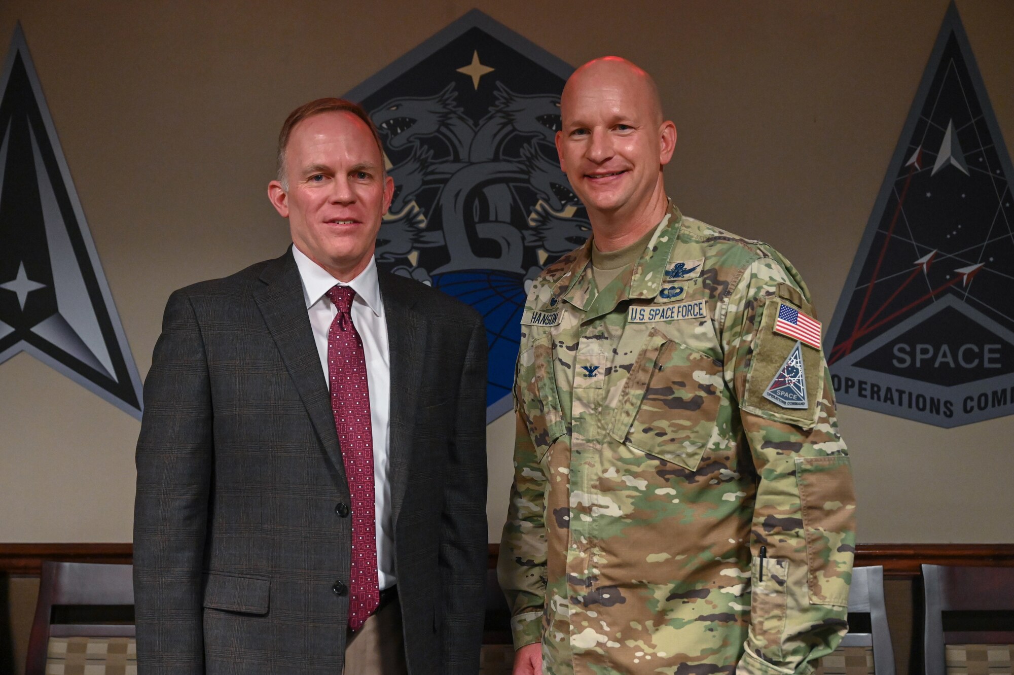 From the left, Dr. Brian Kehl, Space Operations Command Deputy to the Commanding General – Support, congratulates U.S. Space Force Col. David Hanson, commander of Space Base Delta 1, for winning the 2023 Commander in Chief’s Annual Award for Installation Excellence at Peterson Space Force Base, Colorado on June 28, 2023.  Peterson SFB was one of the six recipients of a highly competitive presidential award, selected for their exemplary support of Department of Defense missions. (U.S. Space Force Photo by Airman 1st Class Cody Friend)