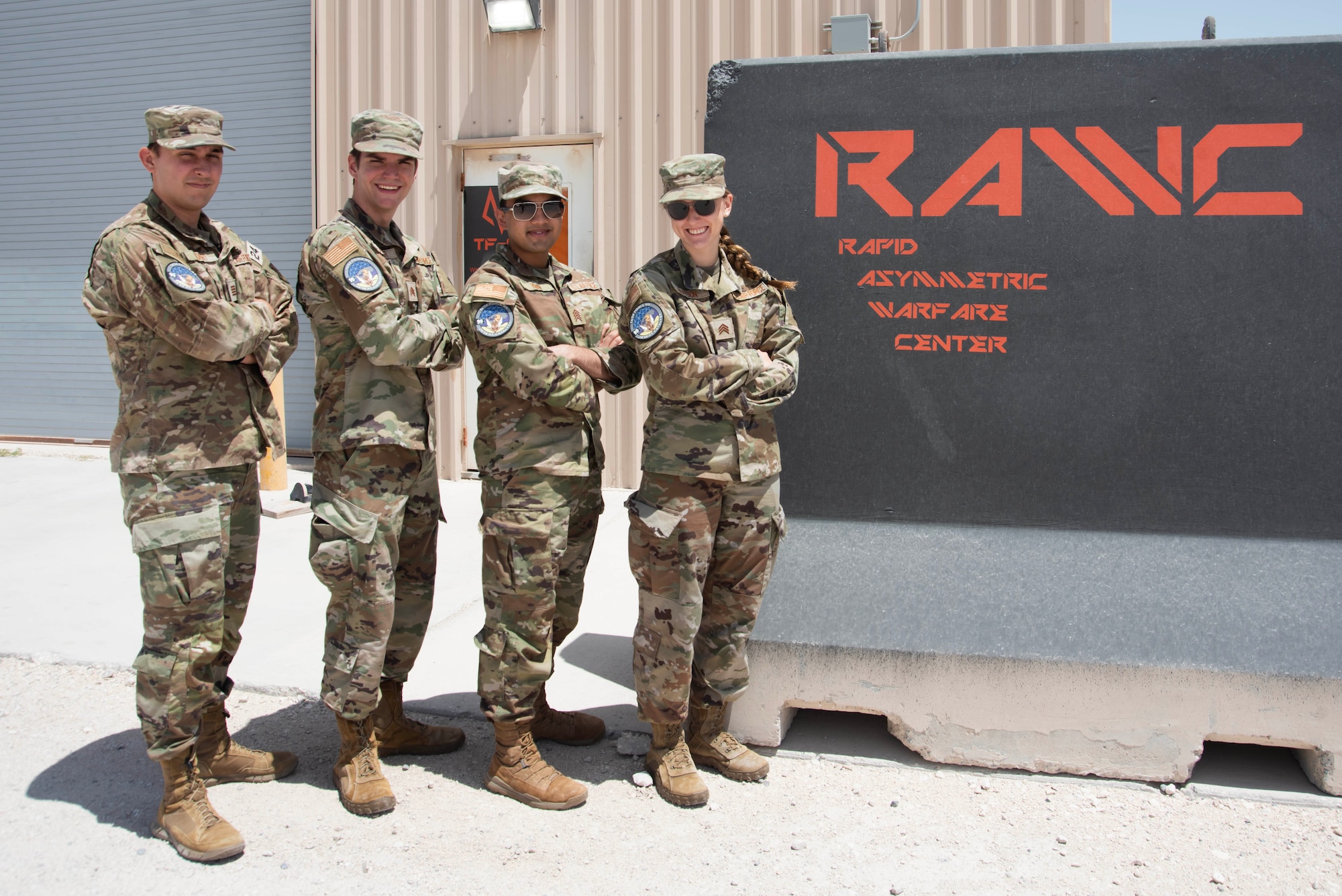 U.S. Air Force Academy cadets pose for a group photo at Task Force 99, Al Udeid Air Base, Qatar, June 22, 2023. The cadets participated in research and innovation at TF 99 as part of the academy’s Cadet Summer Research Program (CSRP). TF 99 is the cornerstone of Ninth Air Force (AFCENT)’s approach to U.S. Central Command’s intent of building a Culture of Innovation by using commercial and government off-the-shelf technology and partnering with Academia, Industry, and coalition members in order to solve operational problem sets. (U.S. Air Force photo by Staff Sgt. Jennifer Zima)