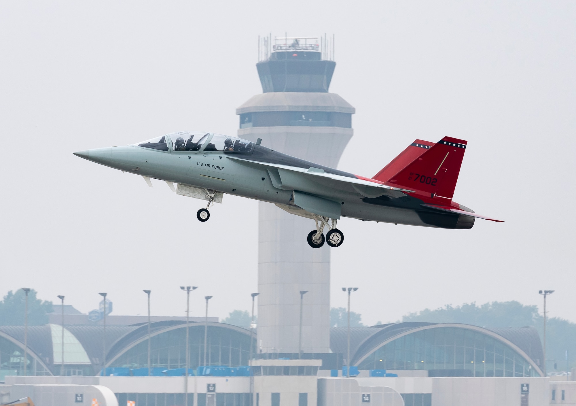 A T-7A Red Hawk, piloted by Maj. Bryce Turner, 416th Flight Test Squadron, takes off from St. Louis Lambert International Airport, St. Louis, Missouri, June 28. During the flight Turner became the first Air Force pilot to fly the T-7A. (Photo courtesy of Boeing)