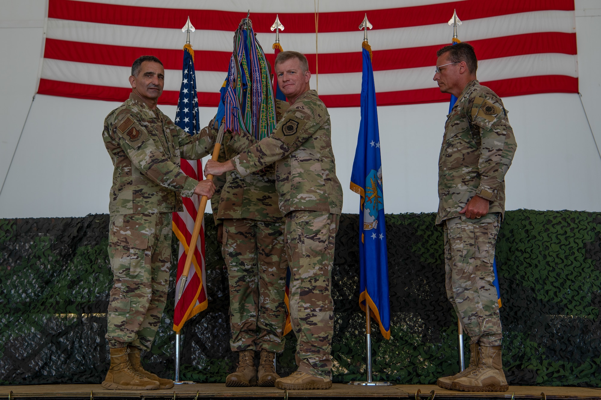 U.S. Air Force Lt. Gen. David Nahom, commander, 11th Air Force, passes the 36th Wing guidon to Brig. Gen. Paul Fast, 36th Wing commander, during the 36th WG change of command ceremony, June 30, 2023, at Andersen Air Force Base, Guam.