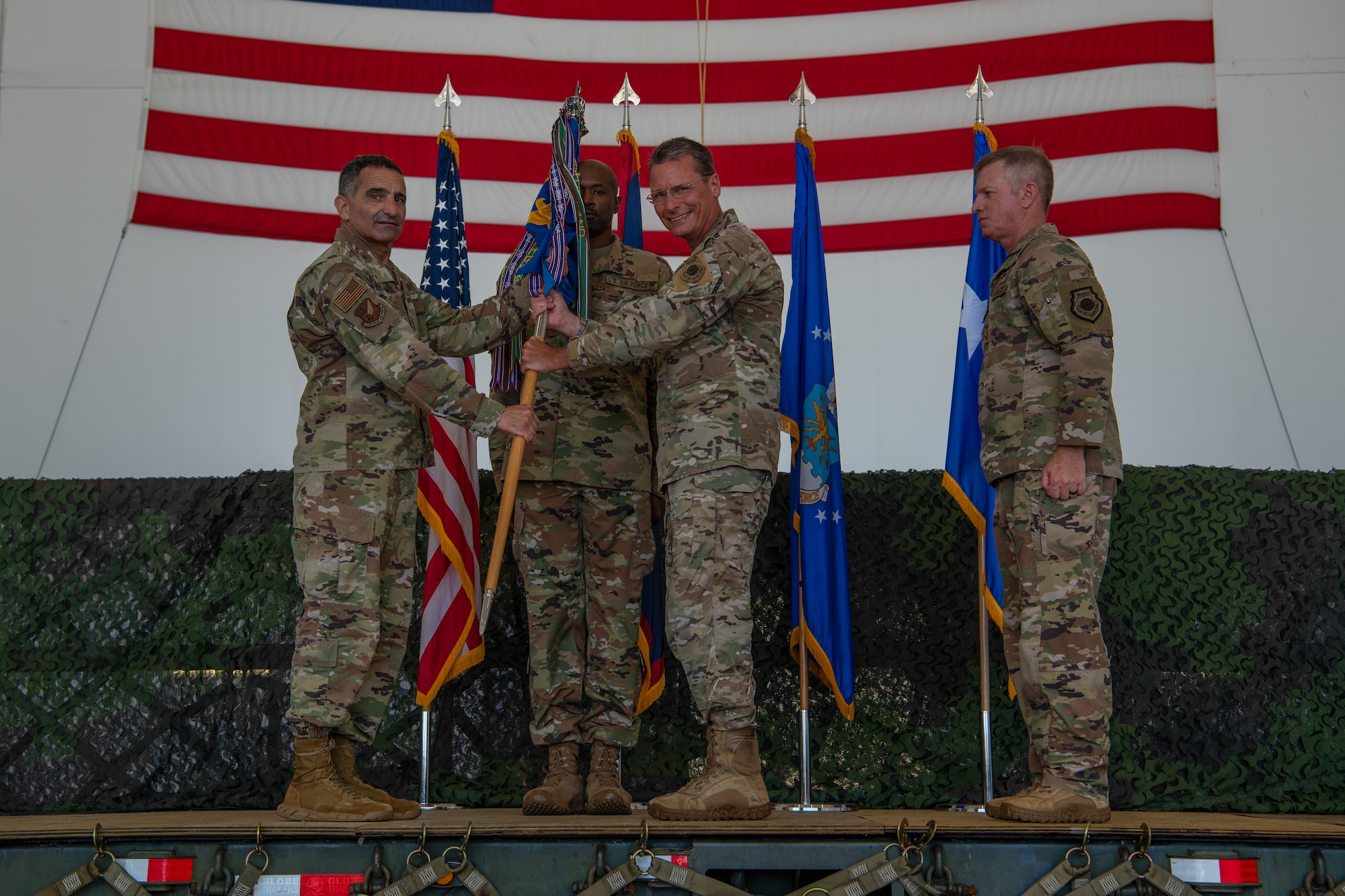 U.S. Air Force Lt. Gen. David Nahom, commander, 11th Air Force, relinquishes the 36th Wing guidon to Brig. Gen. Thomas Palenske, during the 36th Wing change of command ceremony, June 30, 2023, at Andersen Air Force Base, Guam.