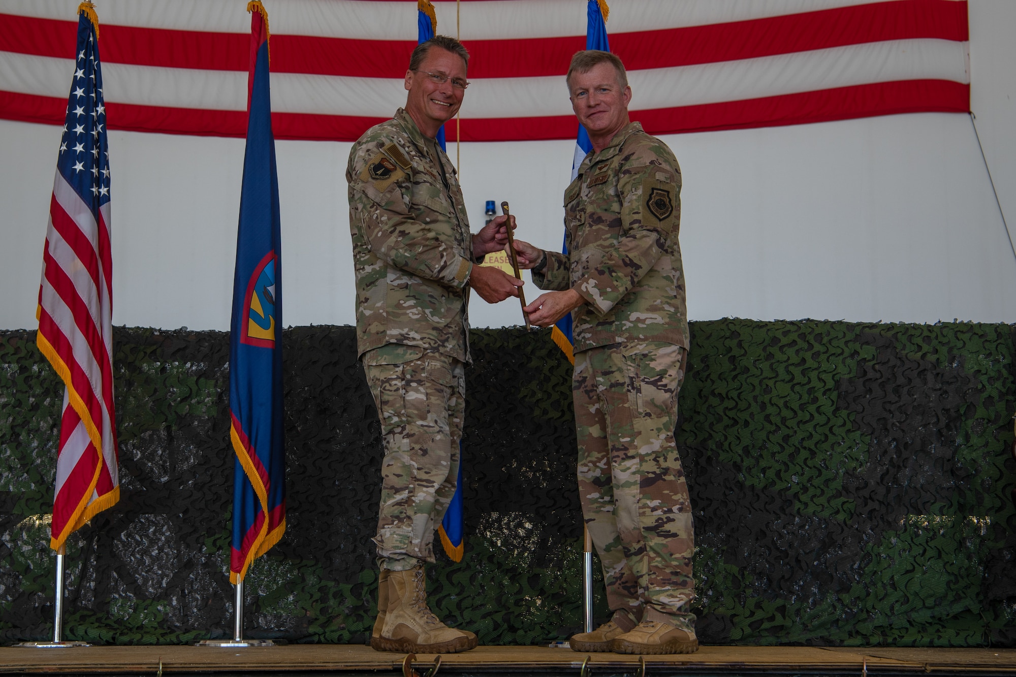 U.S. Air Force Brig. Gen. Thomas Palenske, 36th Wing commander receives a swagger stick from Brig. Gen. Paul Fast, during the 36th Wing change of command ceremony, June 30, 2023, at Andersen Air Force Base, Guam.