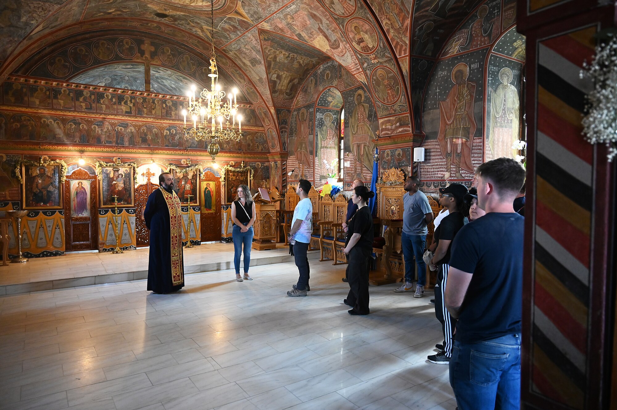 Priest speaks to a group of people