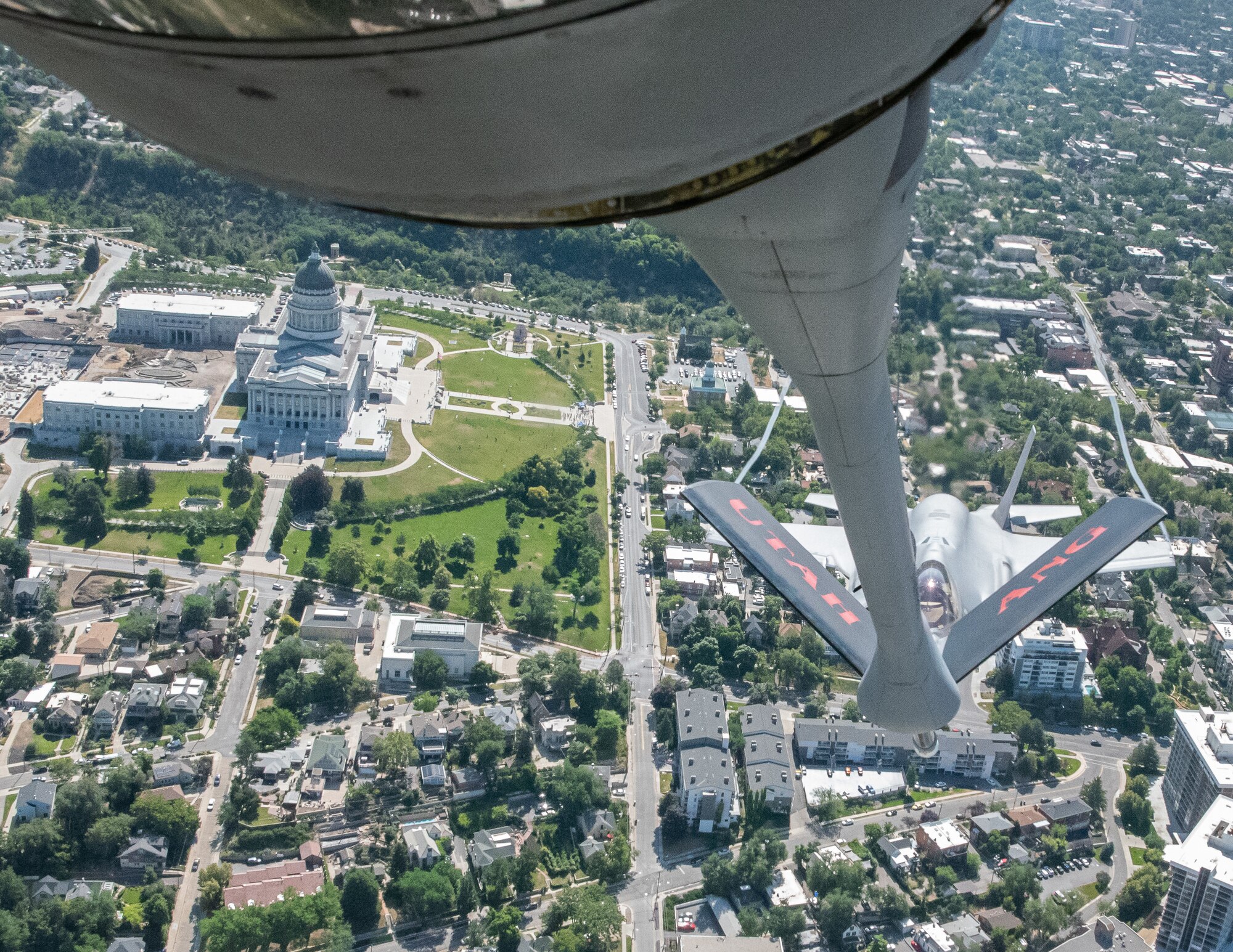 An F-35 fighter aircraft flies with a KC-135 refueler