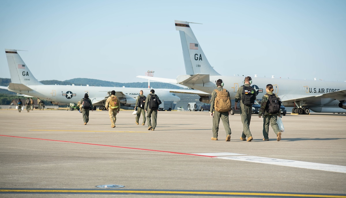 U.S. Air Force Airmen assigned to the 10th Expeditionary Airborne Command and Control Squadron walk toward a Northrop Grumman E-8C Joint Surveillance Target Attack Radar System for the final active duty aircrew flight for the aircraft at Ramstein Air Base, Germany, June 26, 2023. The JSTARS aircraft is being divested and taken over by a more advanced platform intended to keep Airmen safer.