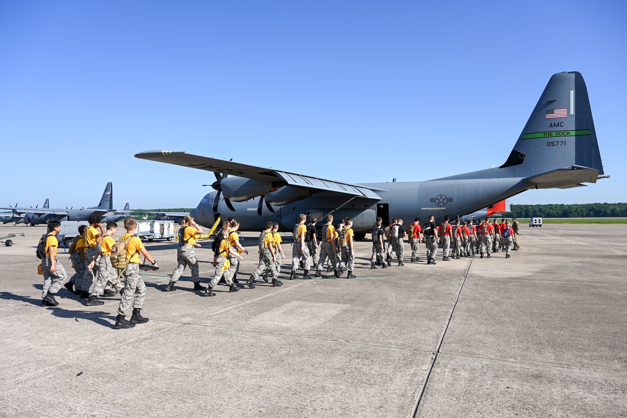 Civil Air Patrol Cadets walk to an aircraft on the flightline