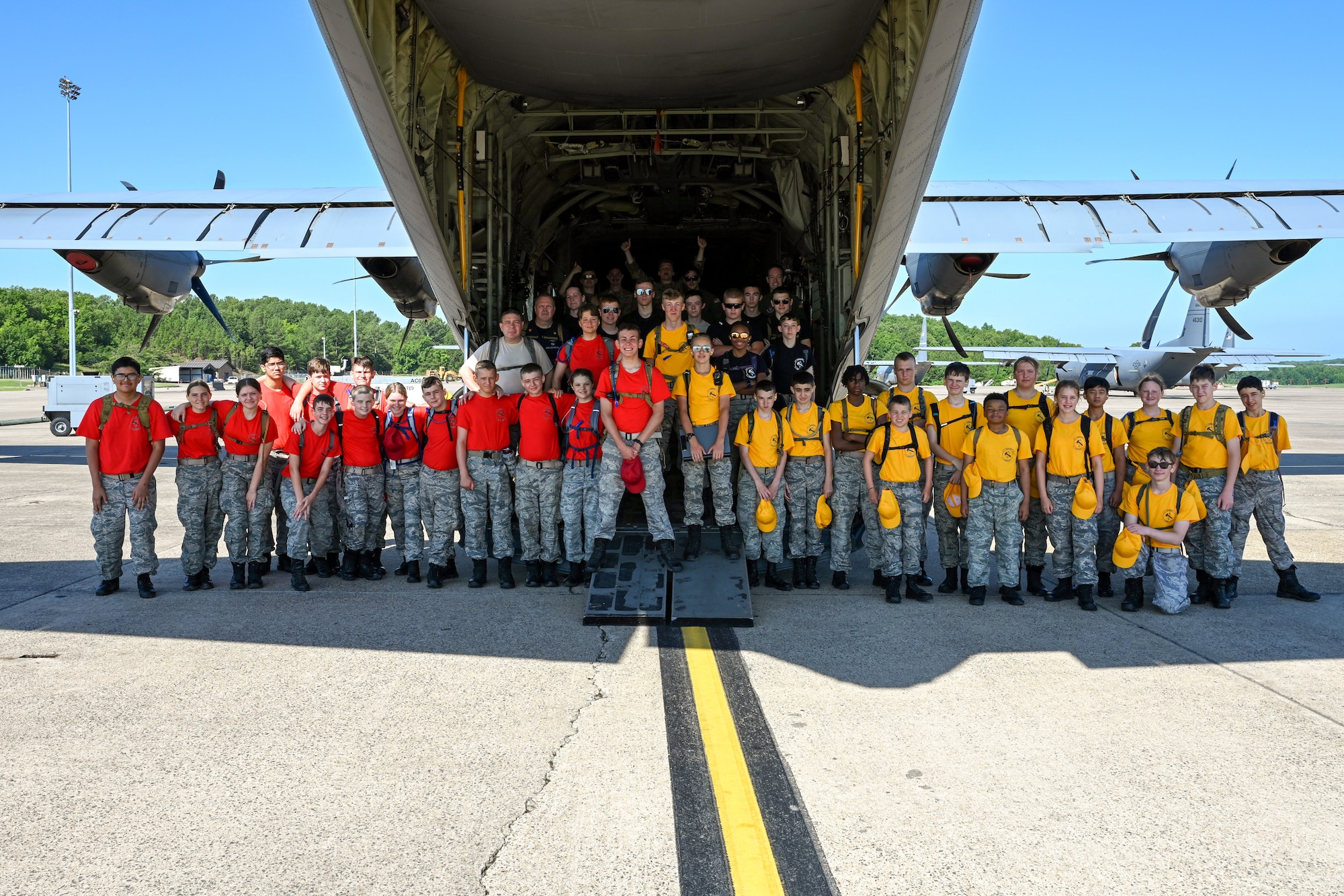 Civil Air Patrol Cadets and Staff take a group photo at the back of an aircraft